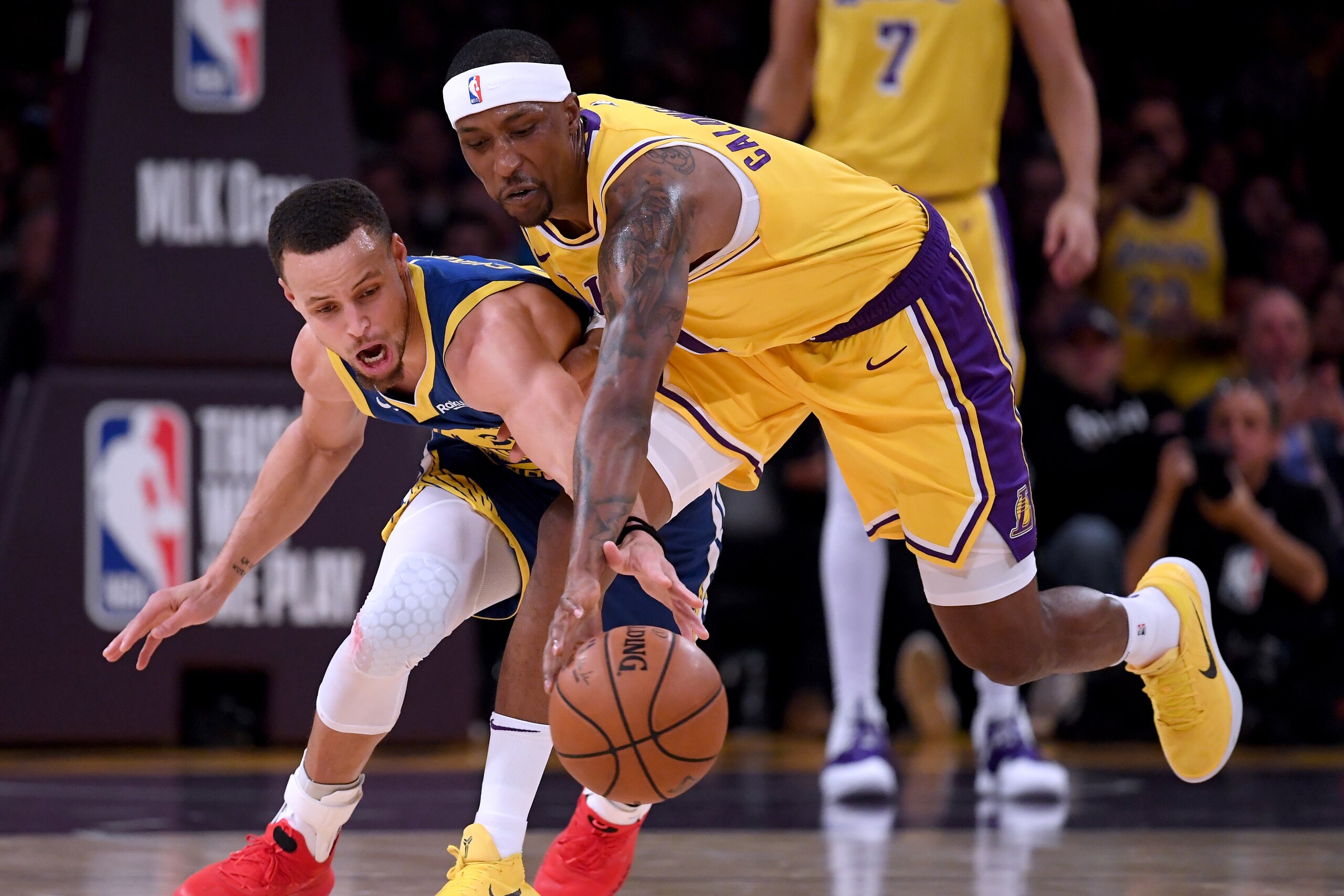 LOS ANGELES, CALIFORNIA - JANUARY 21:  Stephen Curry #30 of the Golden State Warriors and Kentavious Caldwell-Pope #1 of the Los Angeles Lakers reach for a loose ball during a 130-111 Warriors win at Staples Center on January 21, 2019 in Los Angeles, Cali