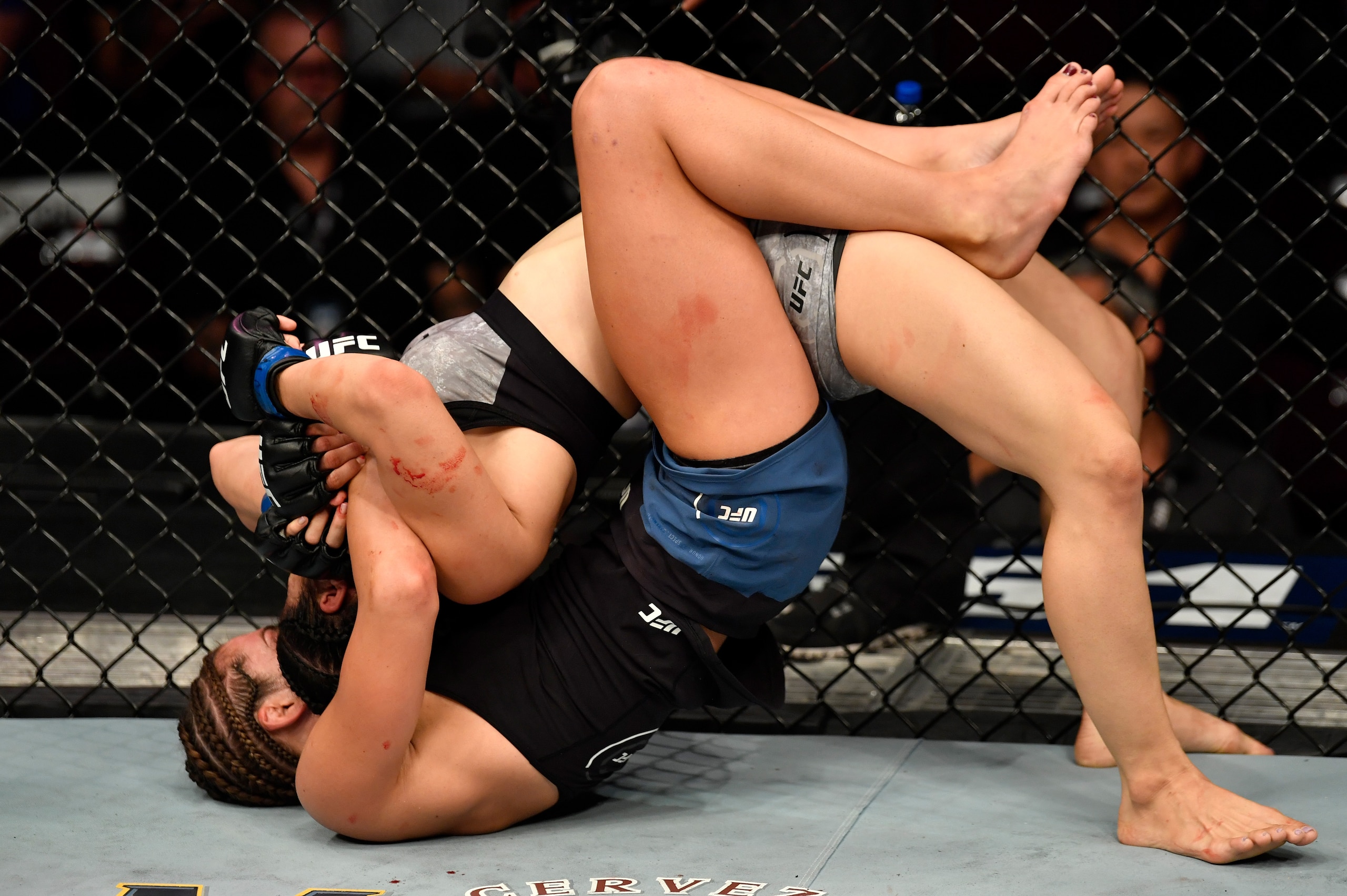 LAS VEGAS, NV - JULY 06:  (L-R) Montana De La Rosa secures a rear choke submission against Rachael Ostovich in their women's flyweight bout during The Ultimate Fighter Finale event inside The Pearl concert theater at Palms Casino Resort on July 6, 2018 in