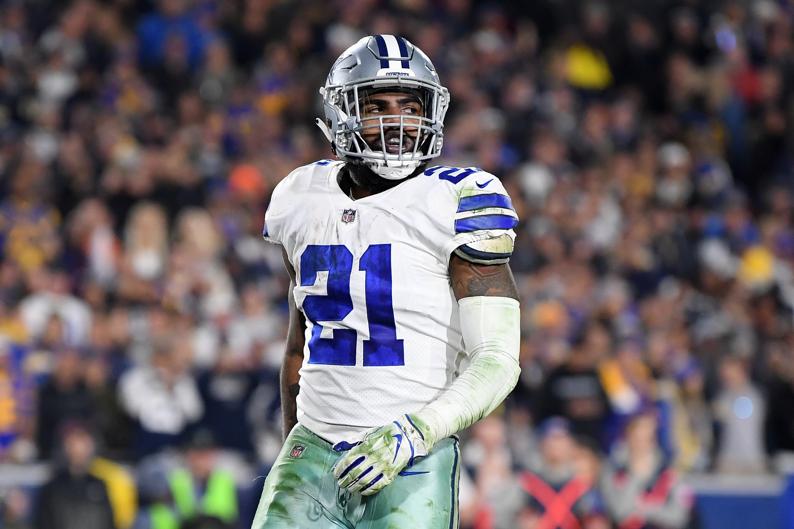 LOS ANGELES, CA - JANUARY 12:  Ezekiel Elliott #21 of the Dallas Cowboys celebrates after scoring a 1 yard touchdown in the third quarter against the Los Angeles Rams in the NFC Divisional Playoff game at Los Angeles Memorial Coliseum on January 12, 2019 