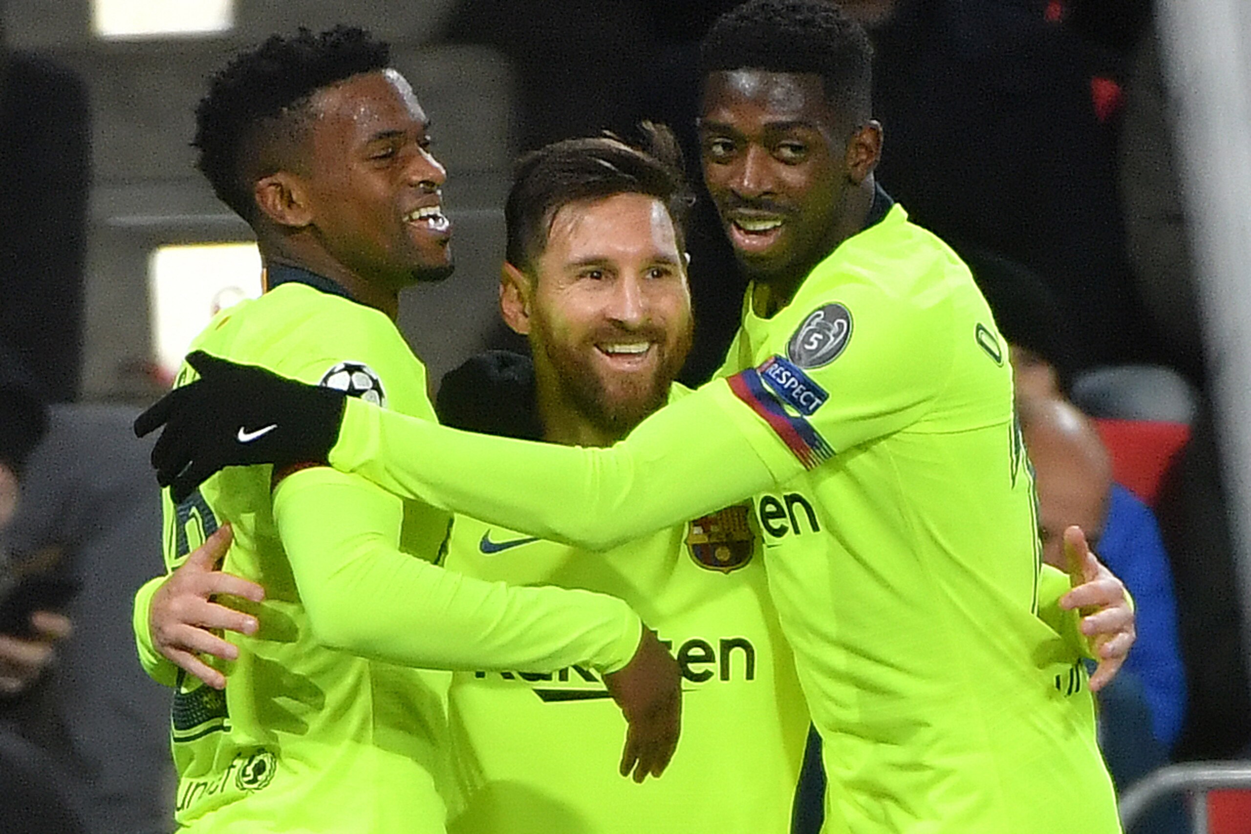 Barcelona's Argentine forward Lionel Messi (C) celebrates with teammates French forward Ousmane Dembele (R) and Portuguese defender Nelson Semedo (L) after scoring during the UEFA Champions League football match between PSV Eindhoven and FC Barcelona at P Barcelona's Argentine forward Lionel Messi (C) celebrates with teammates French forward Ousmane Dembele (R) and Portuguese defender Nelson Semedo (L) after scoring during the UEFA Champions League football match between PSV Eindhoven and FC Barcelona at P