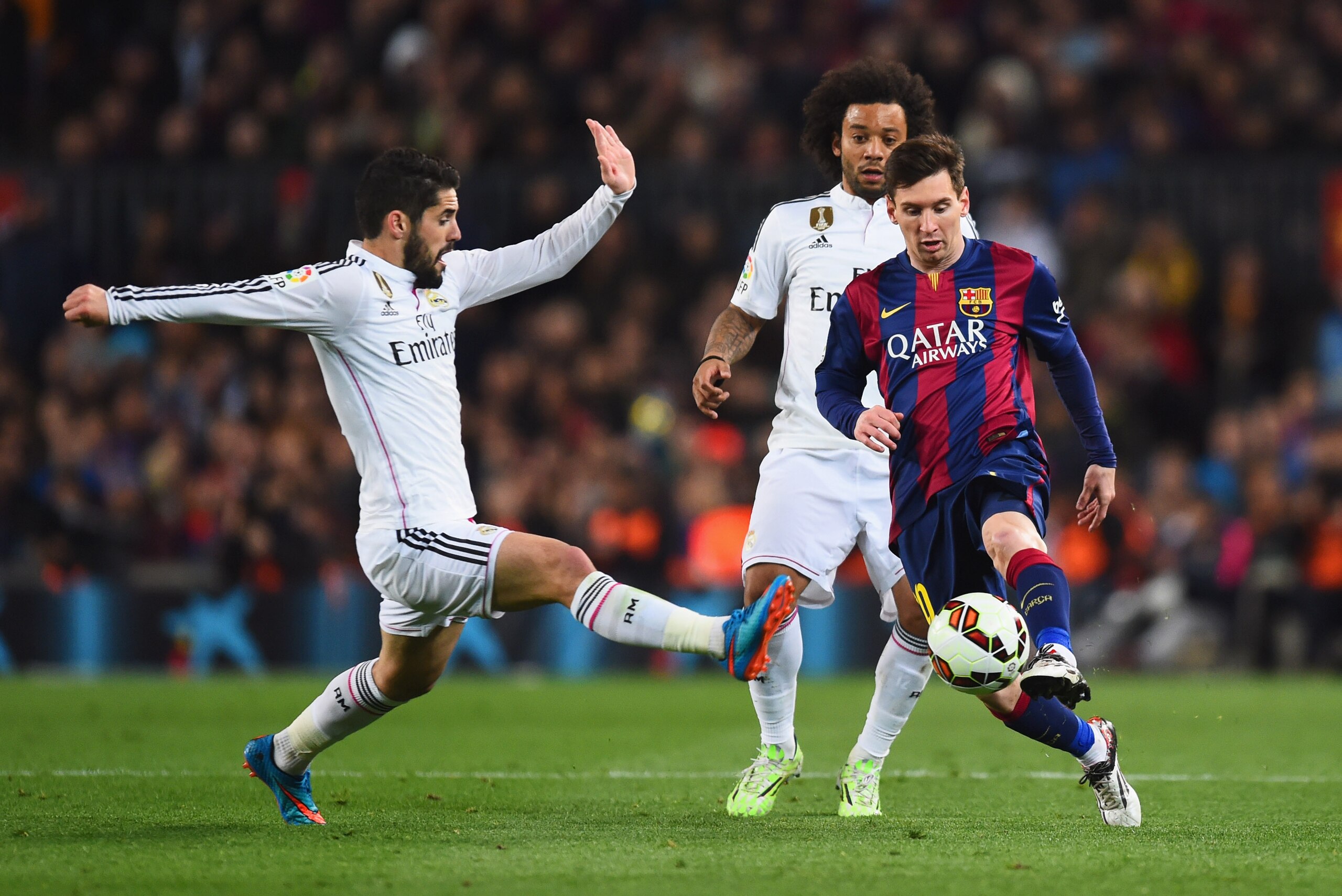BARCELONA, SPAIN - MARCH 22:  Lionel Messi of Barcelona takes on Isco (L) and Marcelo of Real Madrid CF (C) during the La Liga match between FC Barcelona and Real Madrid CF at Camp Nou on March 22, 2015 in Barcelona, Spain.  (Photo by Alex Caparros/Getty 