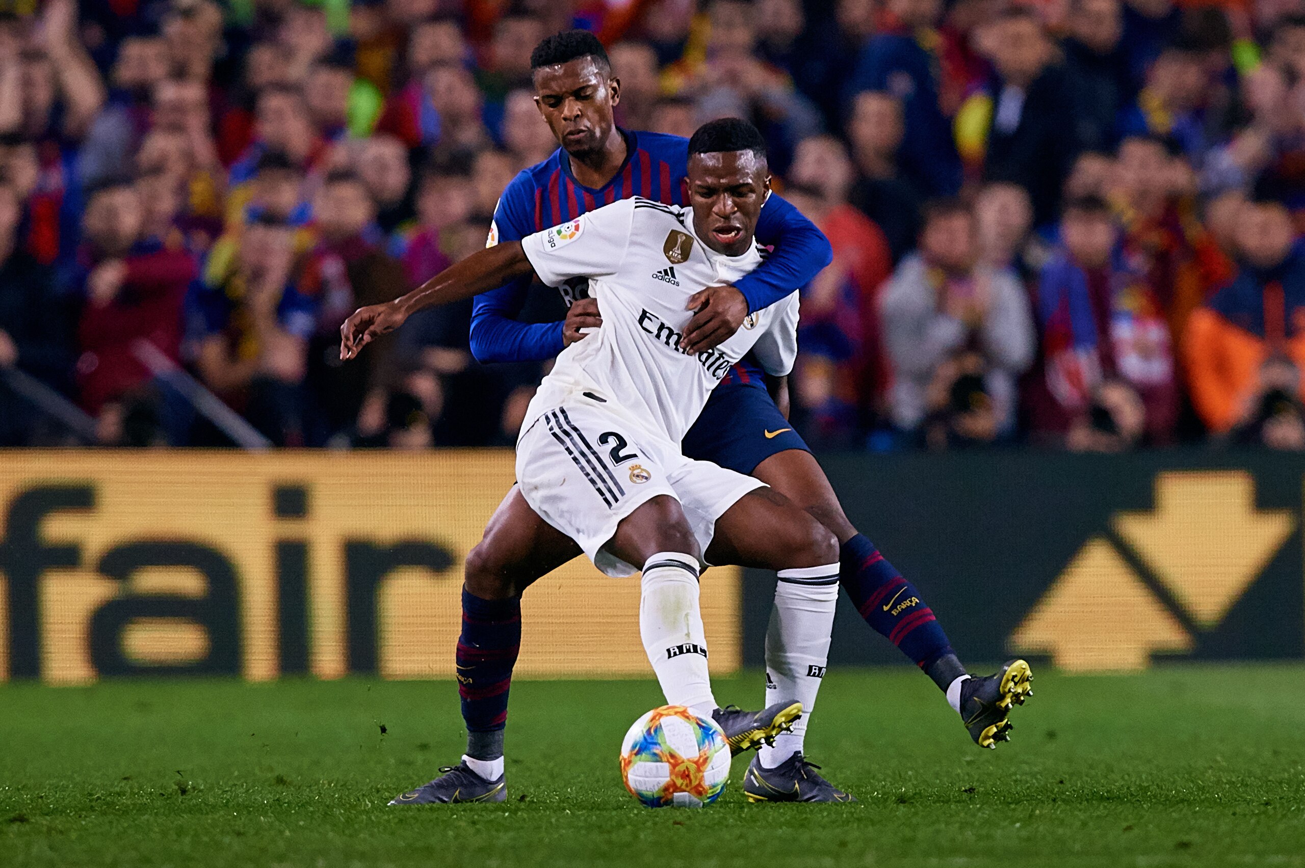 BARCELONA, SPAIN - FEBRUARY 06: Vinicius Junior (R) of Real Madrid CF competes for the ball with Nelson Semedo of FC Barcelona during the Copa del Rey Semi Final match between Barcelona and Real Madrid at Nou Camp on February 6, 2019 in Barcelona, Spain. 