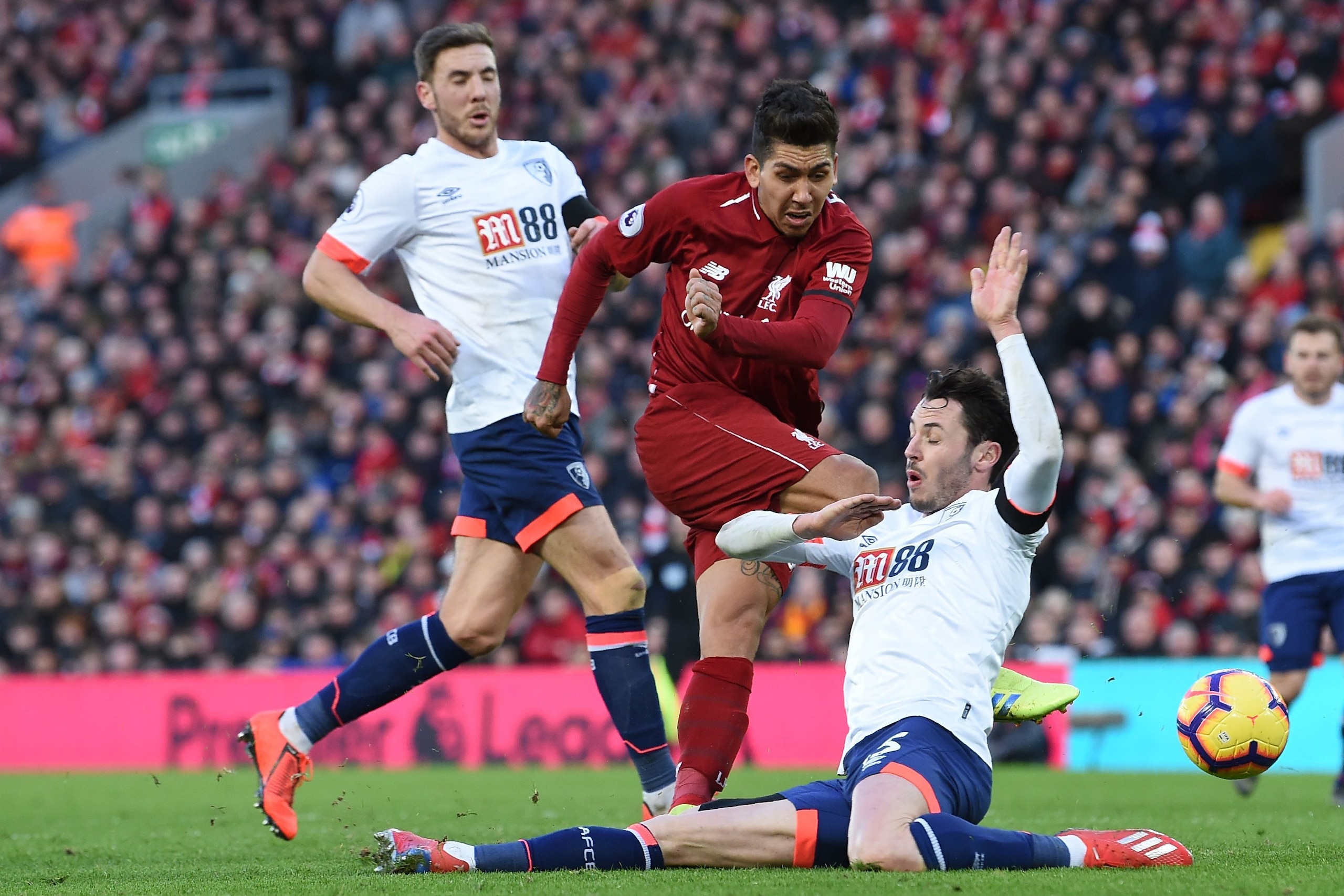 Liverpool's Brazilian midfielder Roberto Firmino (C) has an unsuccessful shot during the English Premier League football match between Liverpool and Bournemouth at Anfield in Liverpool, north west England on February 9, 2019. (Photo by Paul ELLIS / AFP) /