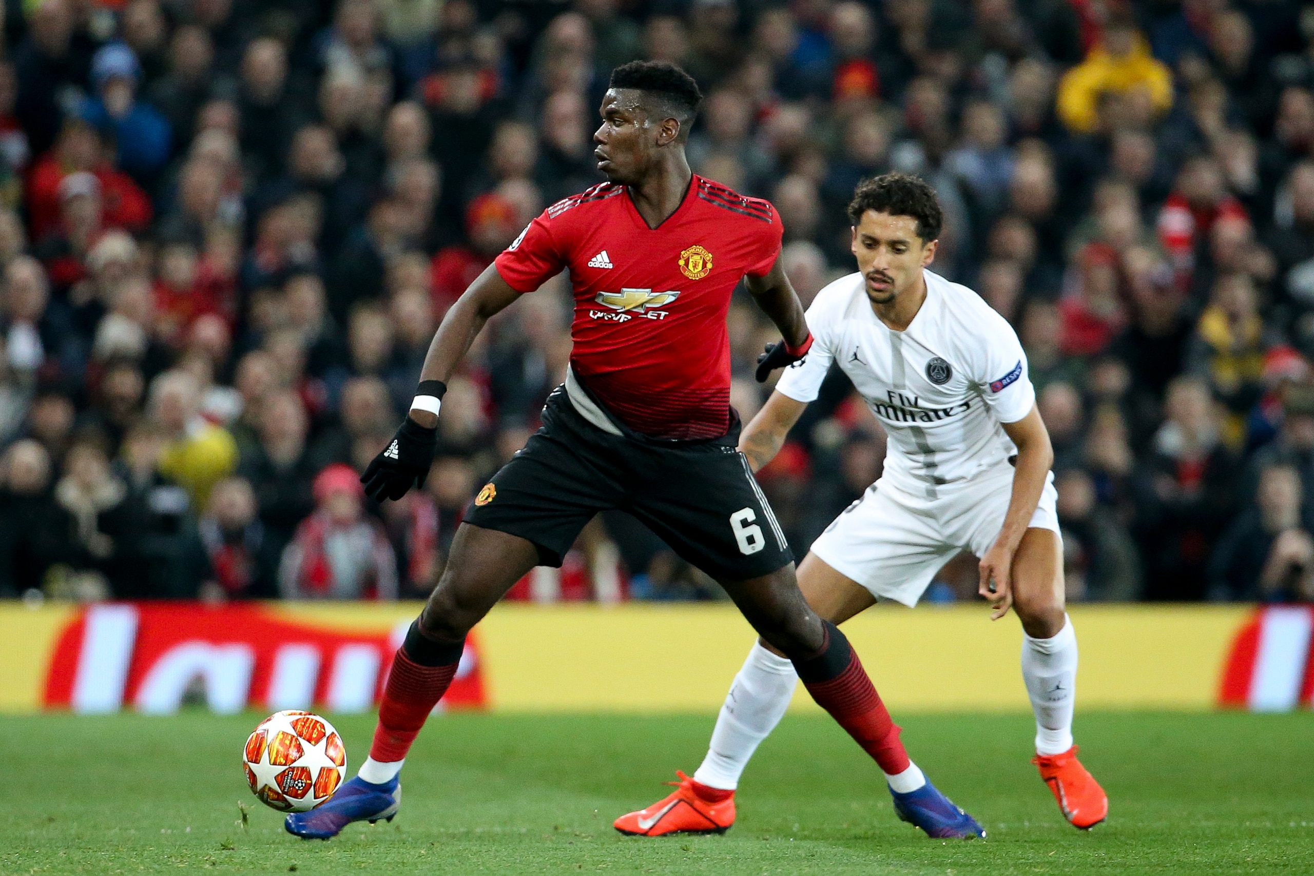 MANCHESTER, ENGLAND - FEBRUARY 12: Paul Pogba of Manchester United, Marquinhos of PSG during the UEFA Champions League Round of 16 First Leg match between Manchester United (Man U) and Paris Saint-Germain (PSG) at Old Trafford stadium on February 12, 2019