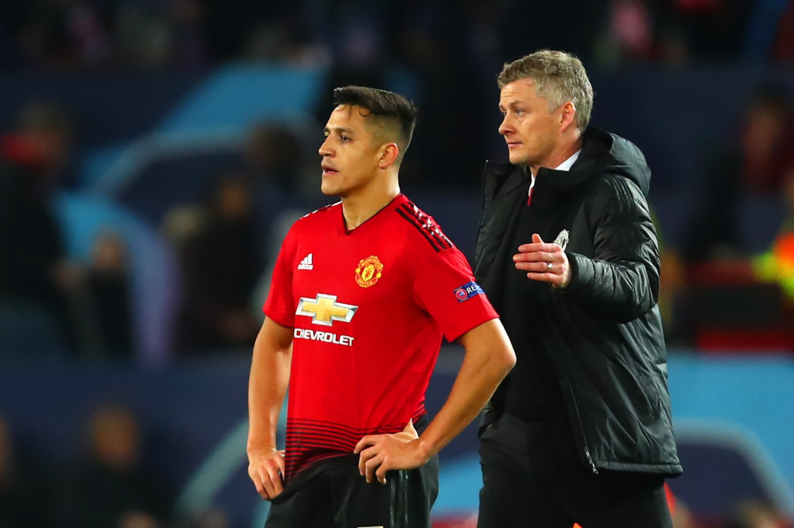 MANCHESTER, ENGLAND - FEBRUARY 12:   Manchester United Head Coach / Manager Ole Gunnar Solskjaer consoles Alexis Sanchez of Manchester United at the end of the UEFA Champions League Round of 16 First Leg match between Manchester United and Paris Saint-Ger