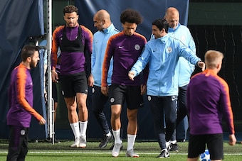 Manchester City's English defender Kyle Walker (2L), Manchester City's Spanish manager Pep Guardiola (C), Manchester City's German midfielder Leroy Sane (centre R), and Spanish assitant coach Mikel Arteta (3R) attend a training session at City Football Ac