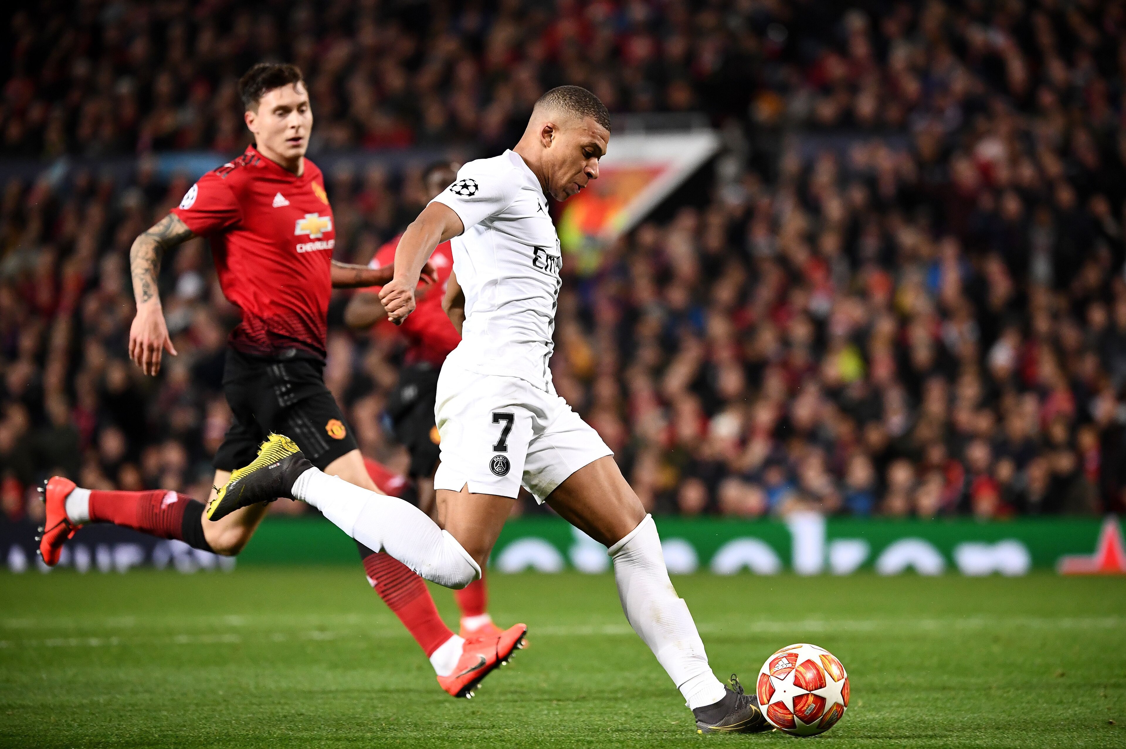 Paris Saint-Germain's French forward Kylian Mbappe (R) plays the ball during the first leg of the UEFA Champions League round of 16 football match between Manchester United and Paris Saint-Germain (PSG) at Old Trafford in Manchester, north-west England on Paris Saint-Germain's French forward Kylian Mbappe (R) plays the ball during the first leg of the UEFA Champions League round of 16 football match between Manchester United and Paris Saint-Germain (PSG) at Old Trafford in Manchester, north-west England on