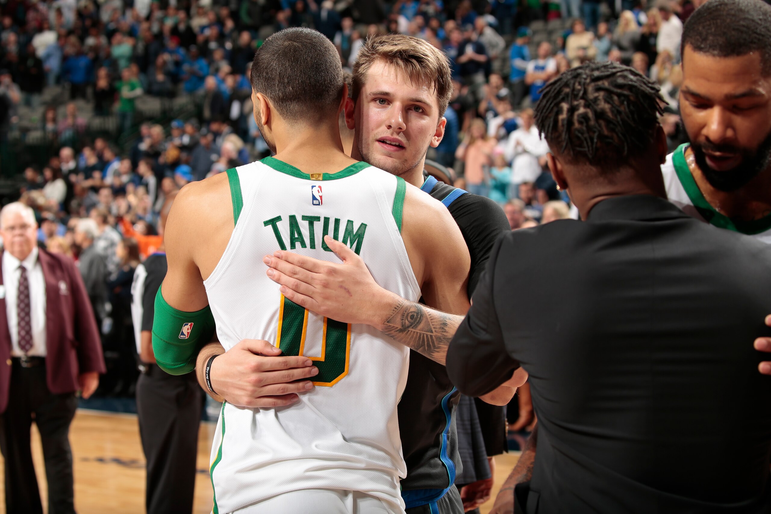 DALLAS, TX - NOVEMBER 24: Jayson Tatum #0 of the Boston Celtics and Luka Doncic #77 of the Dallas Mavericks hug after the game on November 24, 2018 at the American Airlines Center in Dallas, Texas. NOTE TO USER: User expressly acknowledges and agrees that