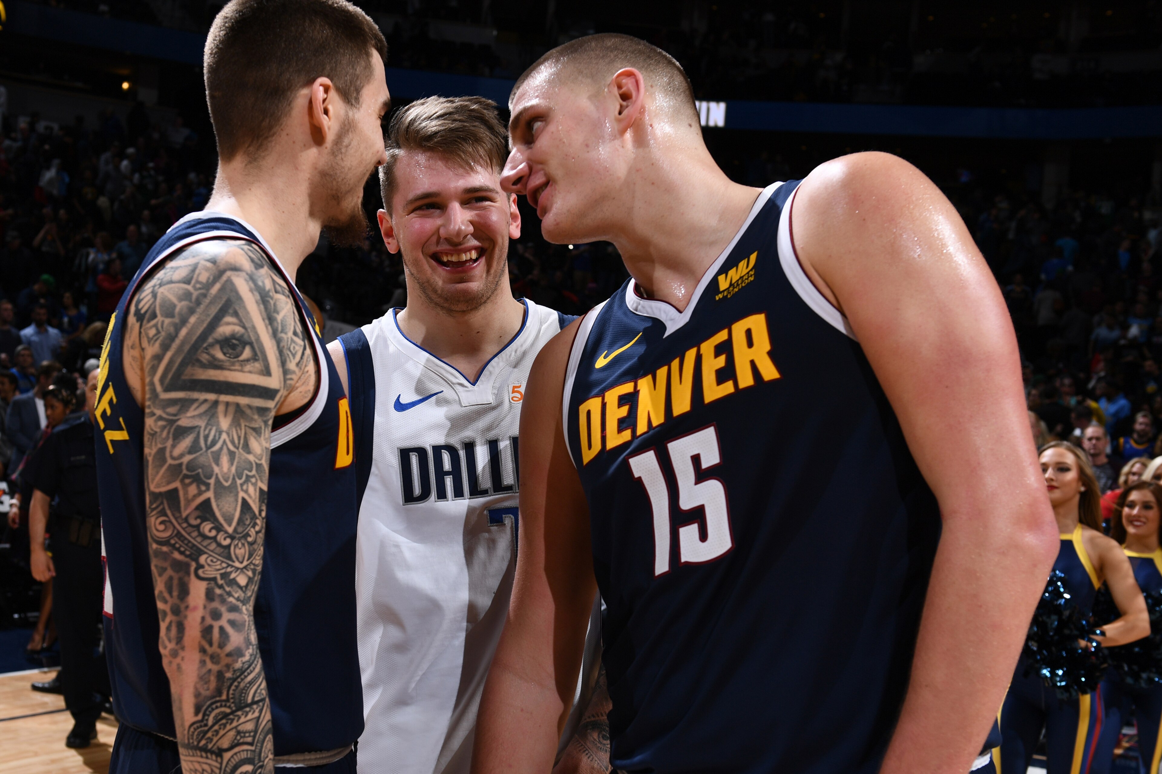 DENVER, CO - DECEMBER 18:  Luka Doncic #77 of the Dallas Mavericks talks with Juan Hernangomez #41 and Nikola Jokic #15 of the Denver Nuggets on December 18, 2018 at the Pepsi Center in Denver, Colorado. NOTE TO USER: User expressly acknowledges and agree