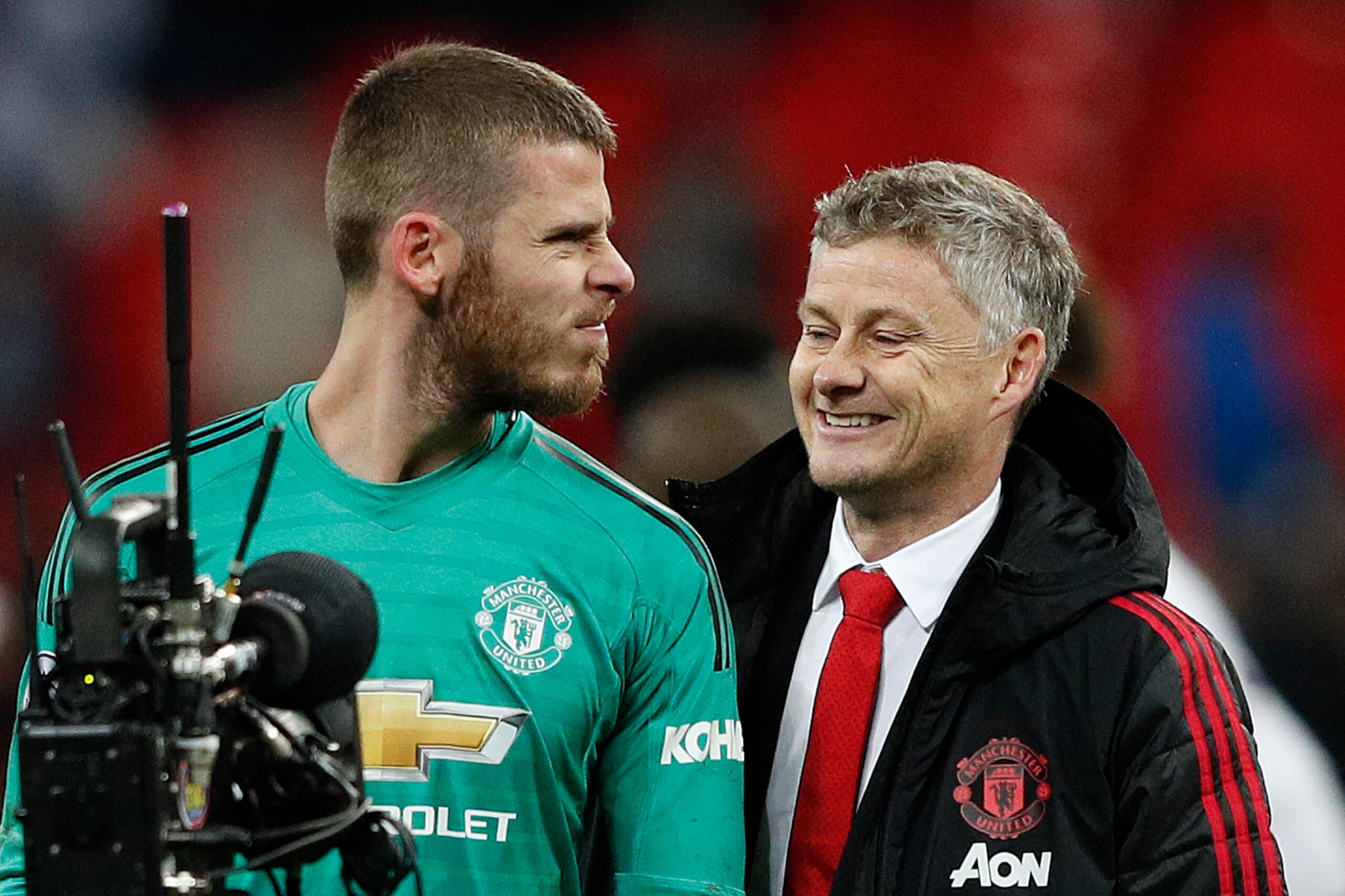 Manchester United's Spanish goalkeeper David de Gea (L) jokes with Manchester United's  Norwegian caretaker manager Ole Gunnar Solskjaer following the English Premier League football match between Tottenham Hotspur and Manchester United at Wembley Stadium