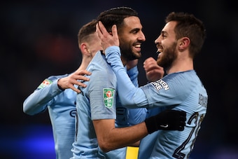 MANCHESTER, ENGLAND - JANUARY 09:  Riyad Mahrez of Manchester City celebrates with Bernardo Silva as he scores his team's ninth goal during the Carabao Cup Semi Final First Leg match between Manchester City and Burton Albion at Etihad Stadium on January 9