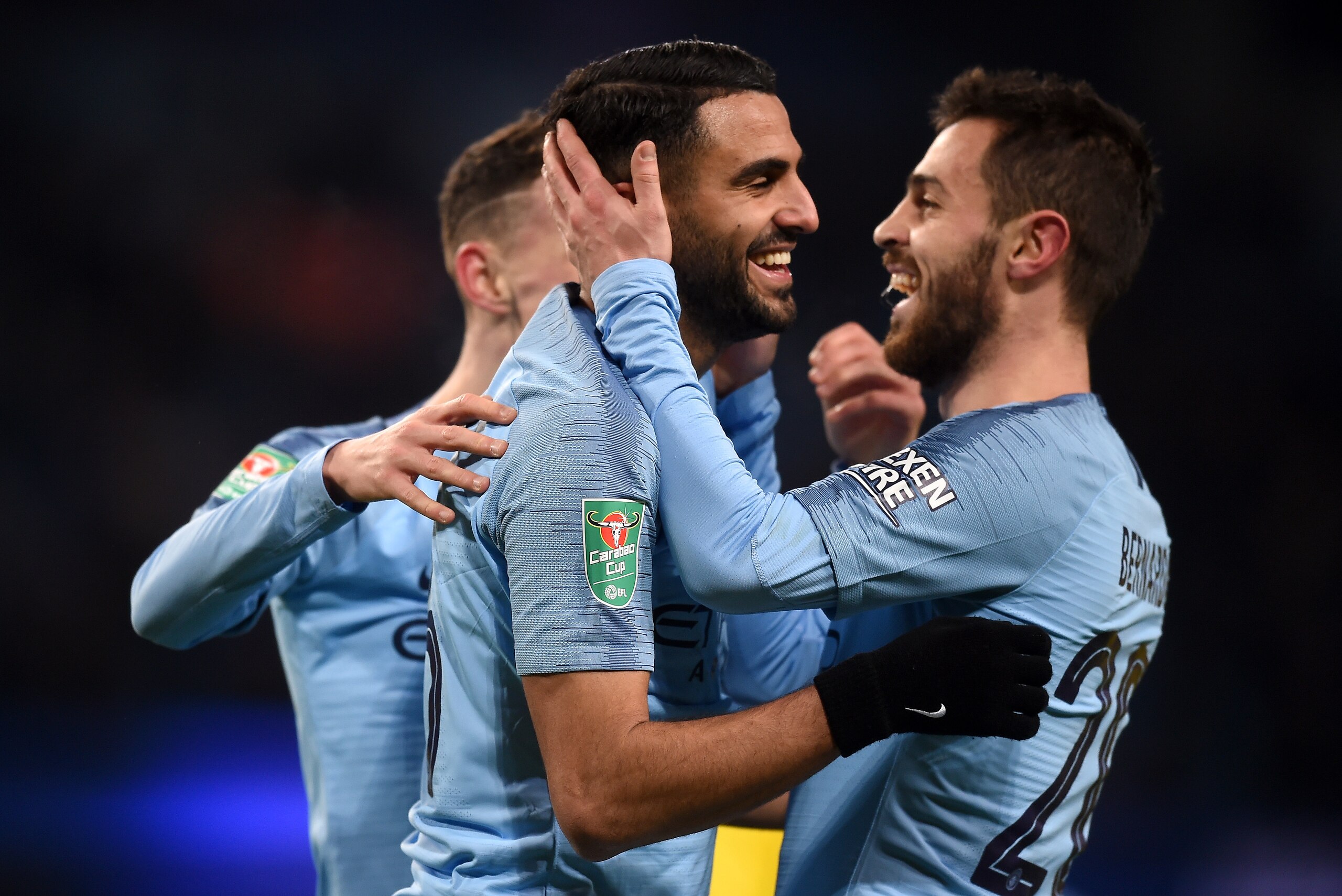 MANCHESTER, ENGLAND - JANUARY 09:  Riyad Mahrez of Manchester City celebrates with Bernardo Silva as he scores his team's ninth goal during the Carabao Cup Semi Final First Leg match between Manchester City and Burton Albion at Etihad Stadium on January 9