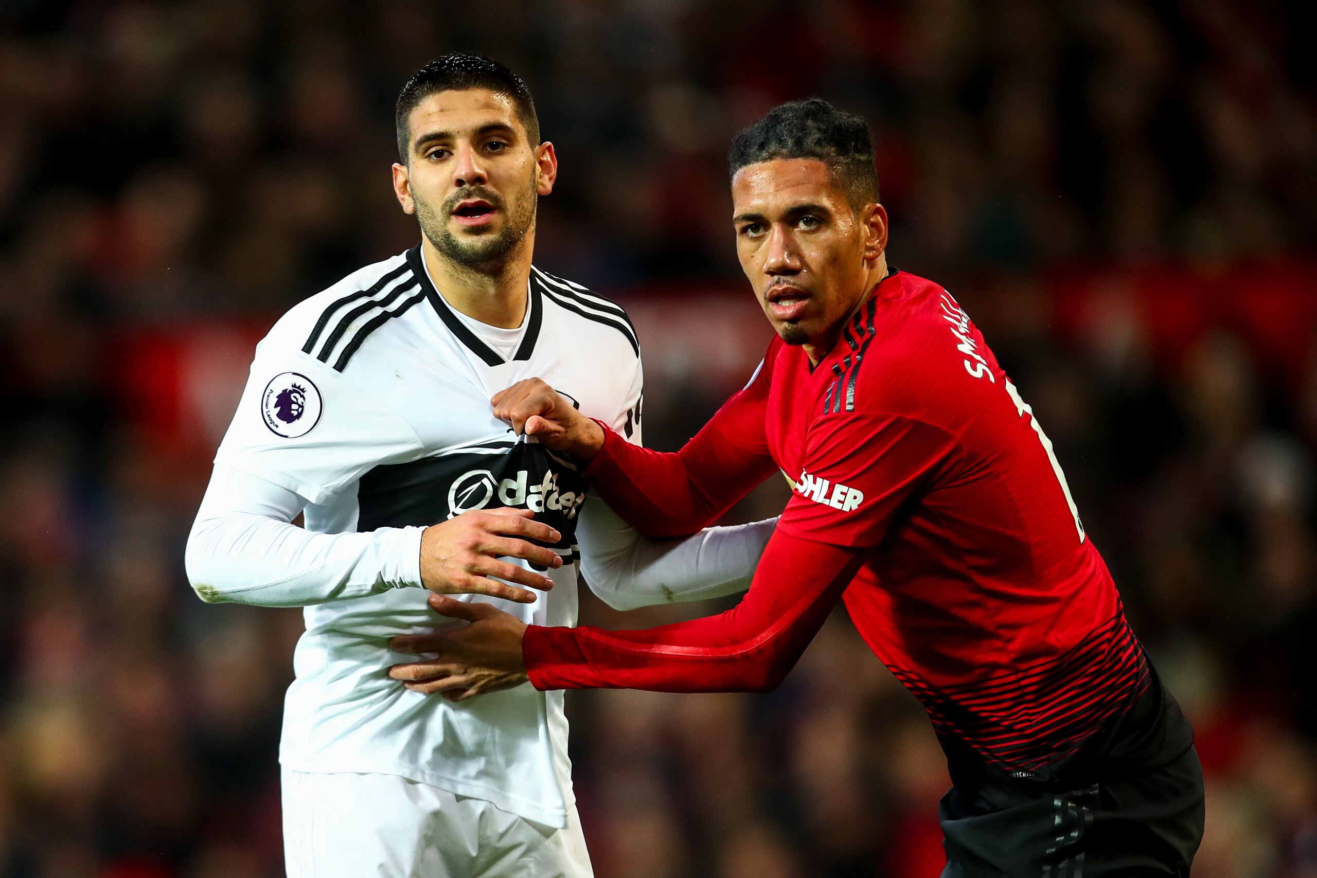 MANCHESTER, ENGLAND - DECEMBER 08: Aleksandar Mitrovic of Fulham and Chris Smalling of Manchester Unitedduring the Premier League match between Manchester United and Fulham FC at Old Trafford on December 8, 2018 in Manchester, United Kingdom. (Photo by Ro