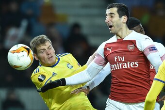 BATE Borisov's Serbian defender Aleksandar Filipovic and Arsenal's Armenian midfielder Henrikh Mkhitaryan vie for the ball during the UEFA Europa League round of 32 first leg football match between FC BATE Borisov and Arsenal FC in Borisov outside Minsk o