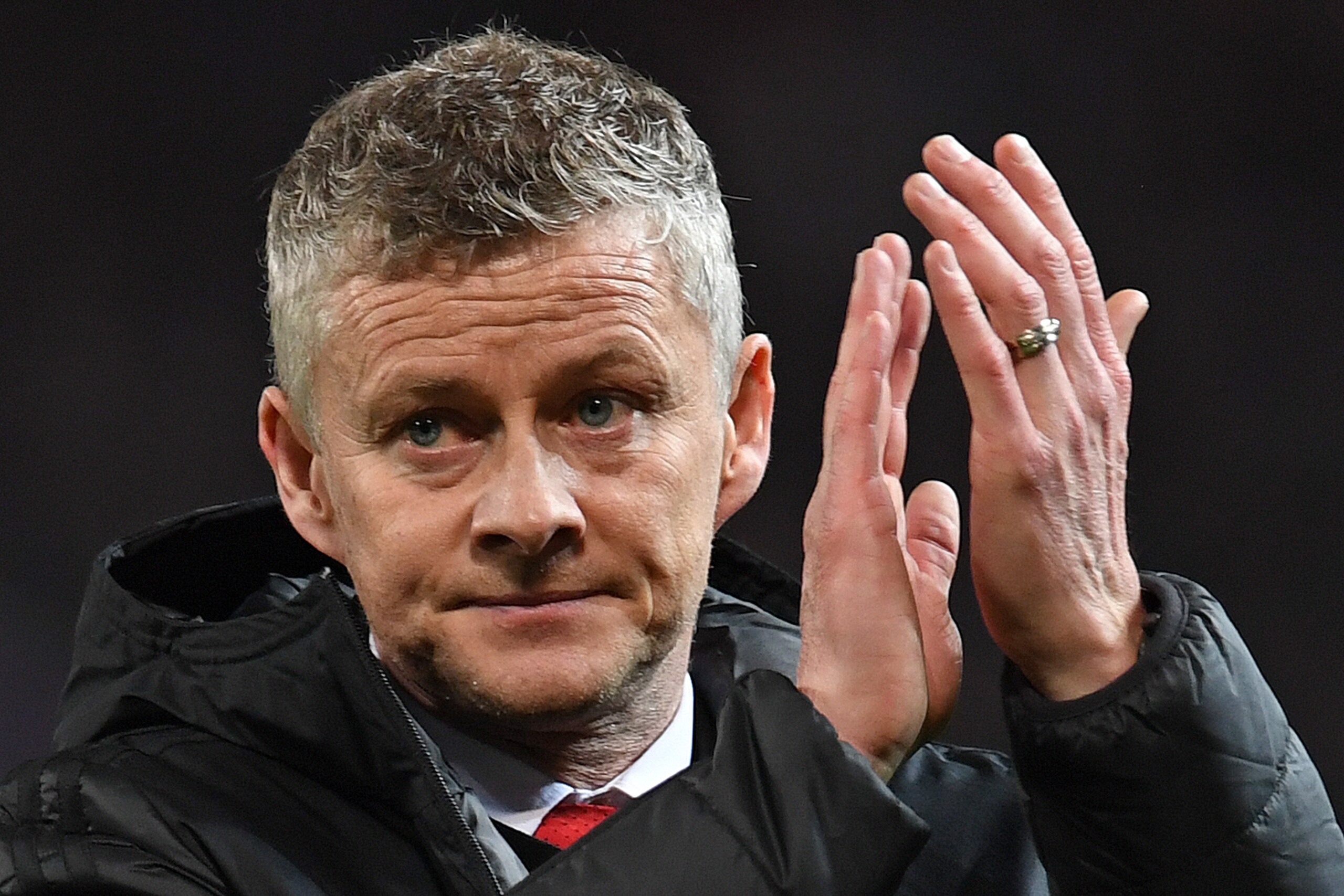 Manchester United's  Norwegian caretaker manager Ole Gunnar Solskjaer applauds the fans following the first leg of the UEFA Champions League round of 16 football match between Manchester United and Paris Saint-Germain (PSG) at Old Trafford in Manchester, 
