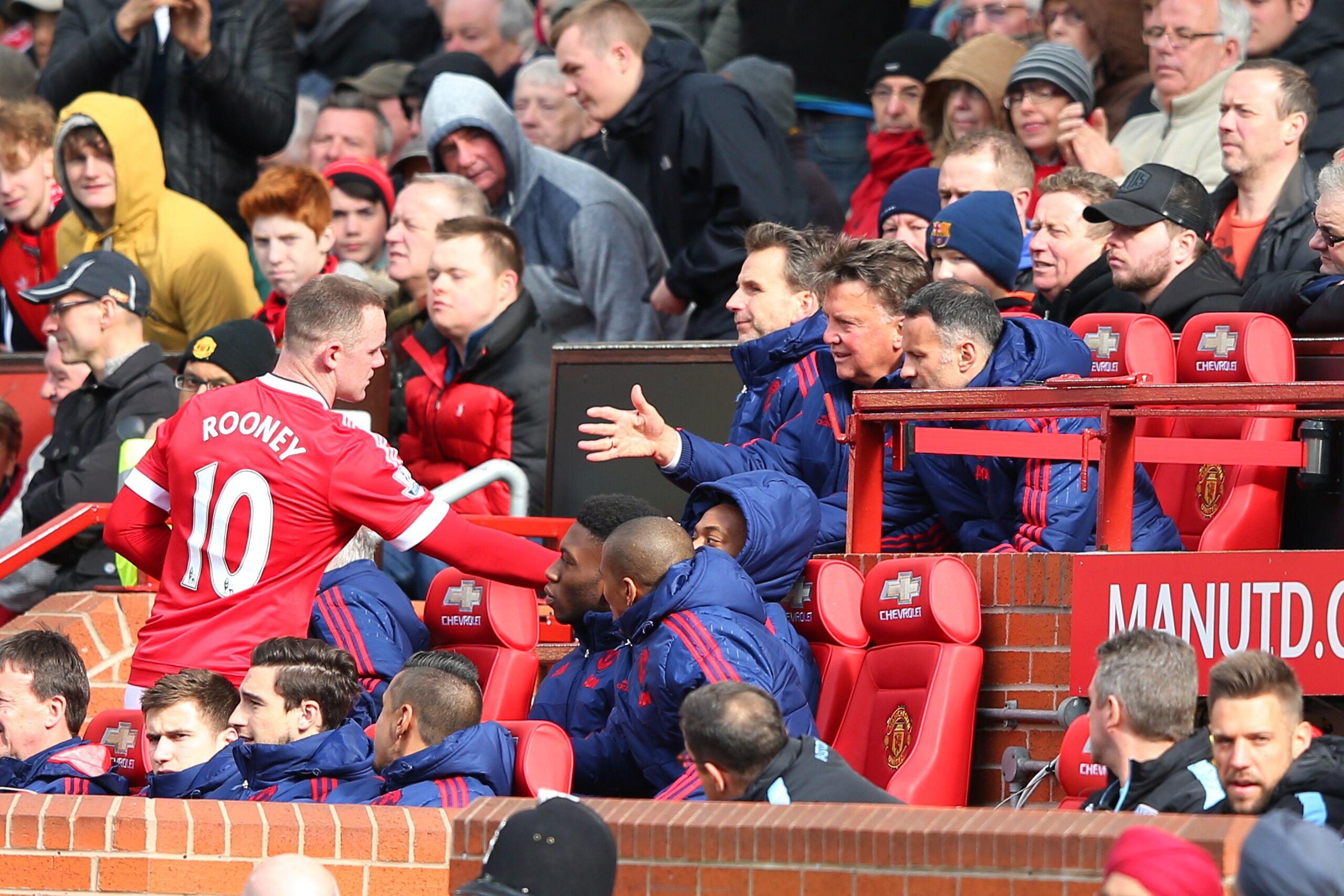 MANCHESTER, ENGLAND - APRIL 16: Wayne Rooney of Manchester United shakes hands with Louis van Gaal, manager of Manchester United and assistant Ryan Giggs during the Barclays Premier League match between Manchester United and Aston Villa at Old Trafford on