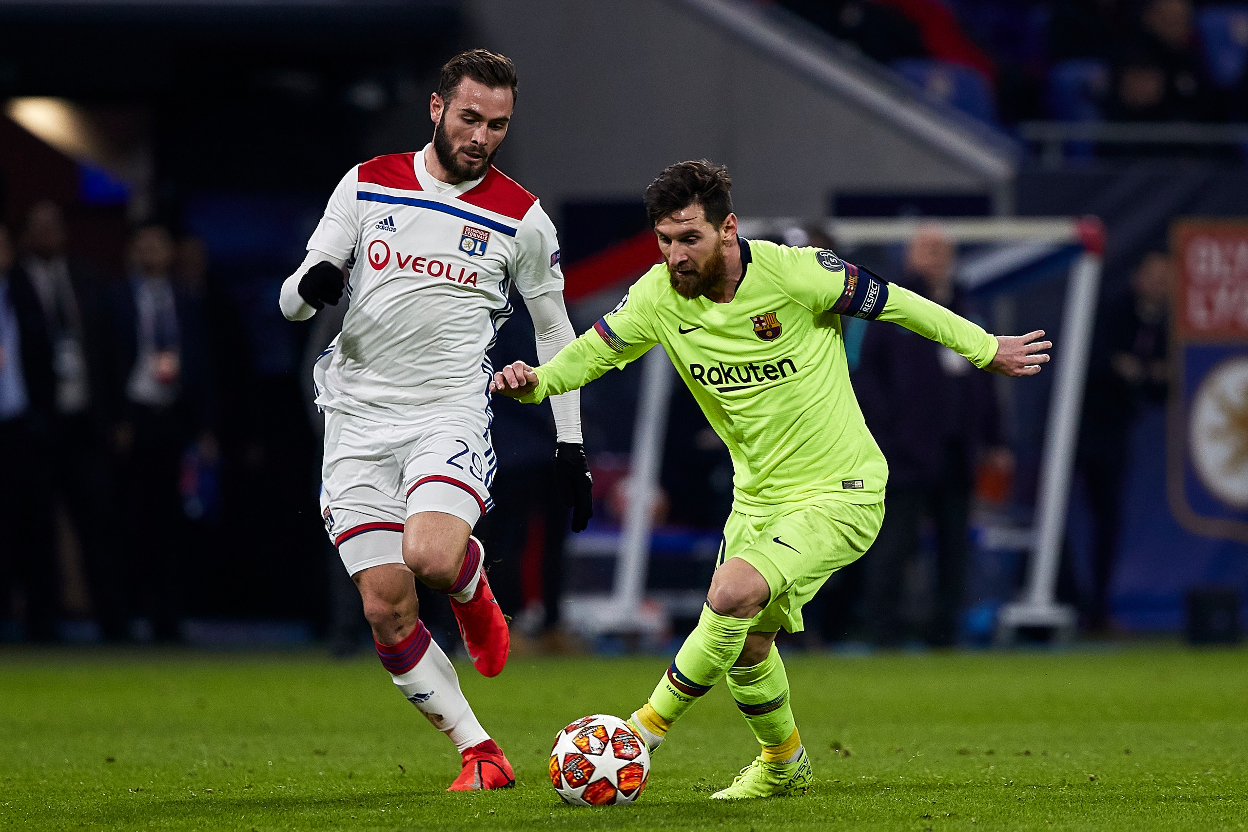 LYON, FRANCE - FEBRUARY 19: Lionel Messi of FC Barcelona competes for the ball with Lucas Tousart of Olympique Lyonnais during the UEFA Champions League Round of 16 First Leg match between Olympique Lyonnais and FC Barcelona at Groupama Stadium on Februar LYON, FRANCE - FEBRUARY 19: Lionel Messi of FC Barcelona competes for the ball with Lucas Tousart of Olympique Lyonnais during the UEFA Champions League Round of 16 First Leg match between Olympique Lyonnais and FC Barcelona at Groupama Stadium on Februar
