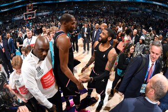 CHARLOTTE, NC - FEBRUARY 17: Kevin Durant #35 and Kyrie Irving #11 of Team LeBron talk after the 2019 NBA All-Star Game on February 17, 2019 at the Spectrum Center in Charlotte, North Carolina. NOTE TO USER: User expressly acknowledges and agrees that, by