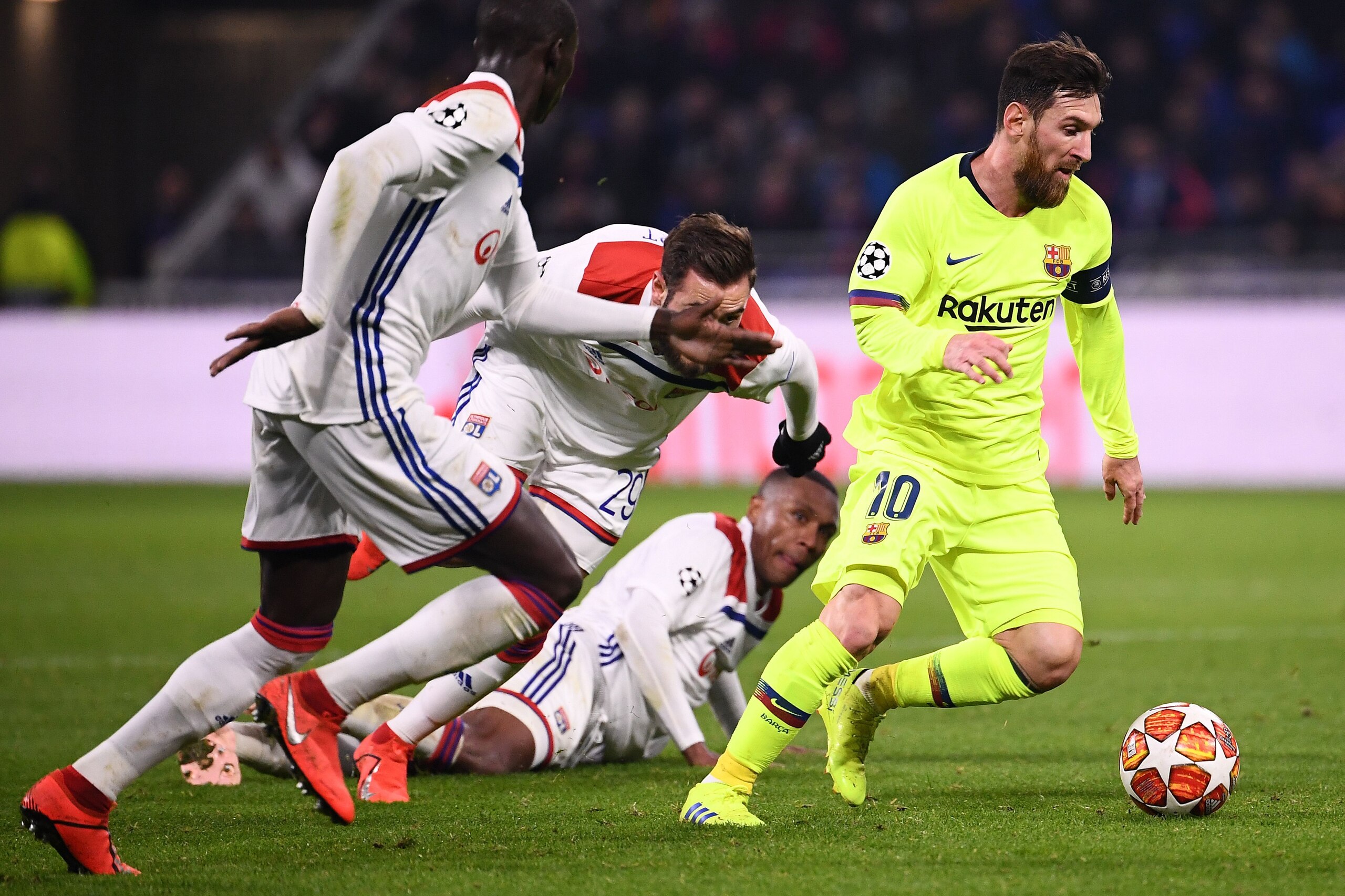 Barcelona's Argentinian forward Lionel Messi (R) plays the ball during the UEFA Champions League round of 16 first leg football match between Lyon (OL) and FC Barcelona on February 19, 2019, at the Groupama Stadium in Decines-Charpieu, central-eastern Fra
