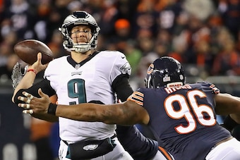 CHICAGO, IL - JANUARY 06:  Nick Foles #9 of the Philadelphia Eagles passes under pressure from Akiem Hicks #96 of the Chicago Bears during an NFC Wild Card playoff game at Soldier Field on January 6, 2019 in Chicago, Illinois. The Eagles defeated the Bear