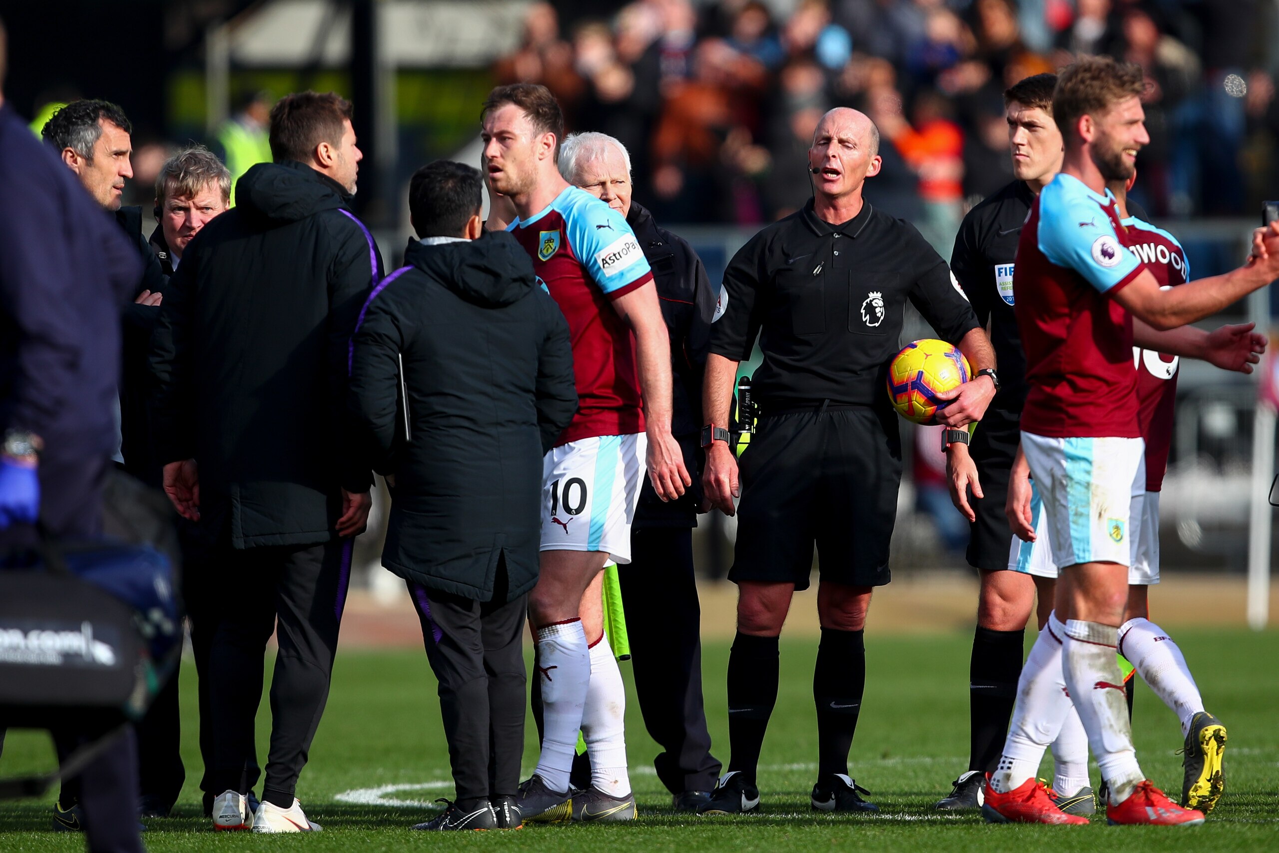 BURNLEY, ENGLAND - FEBRUARY 23: Mauricio Pochettino head coach / manager of Tottenham Hotspur and his coaching staff have a disagreement with Referee Mike Dean at full time during the Premier League match between Burnley FC and Tottenham Hotspur at Turf M