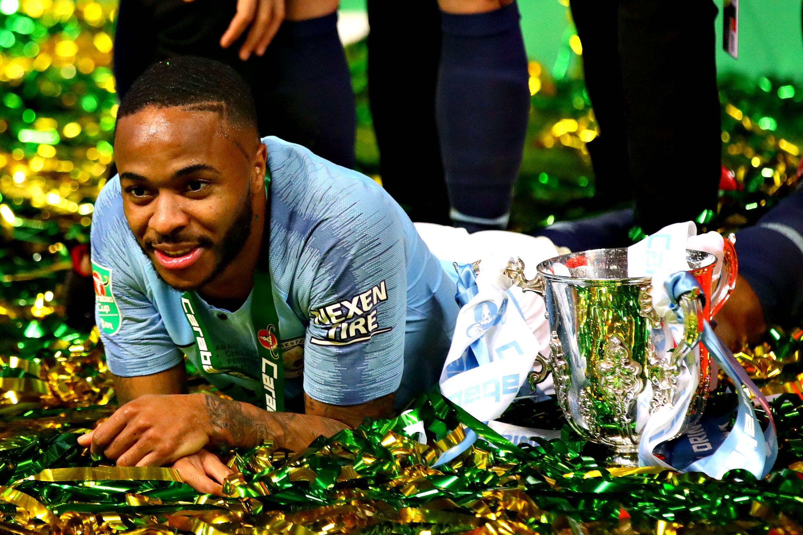 LONDON, ENGLAND - FEBRUARY 24: Raheem Sterling of Manchester City celebrates with the trophy after his side won during the Carabao Cup Final between Chelsea and Manchester City at Wembley Stadium on February 24, 2019 in London, England. (Photo by Chris Br