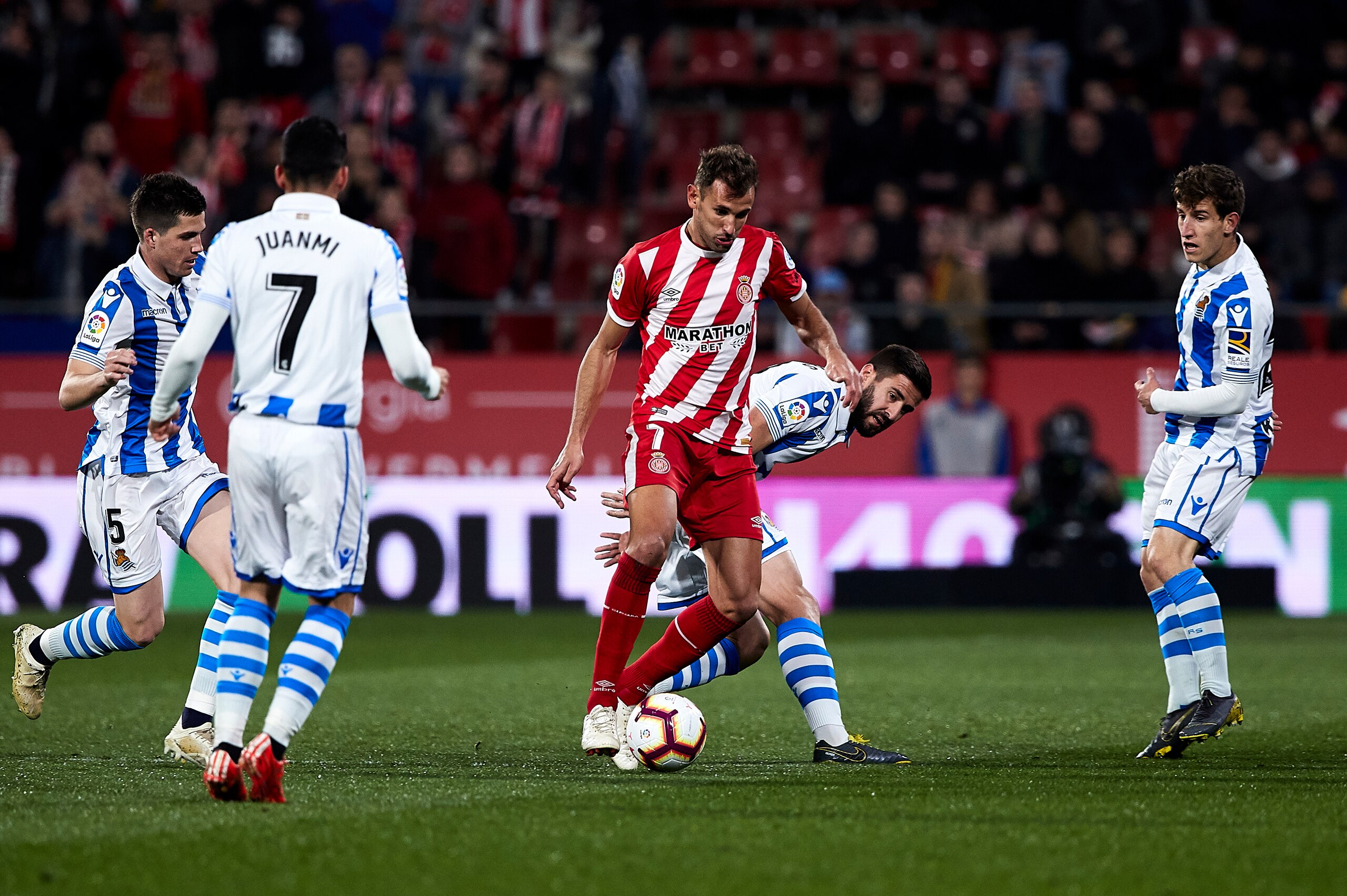 GIRONA, SPAIN - FEBRUARY 25: Cristhian Stuani of Girona FC controls the ball surrounded by players of Real Sociedad during the La Liga match between Girona FC and Real Sociedad at Montilivi Stadium on February 25, 2019 in Girona, Spain. (Photo by Quality 