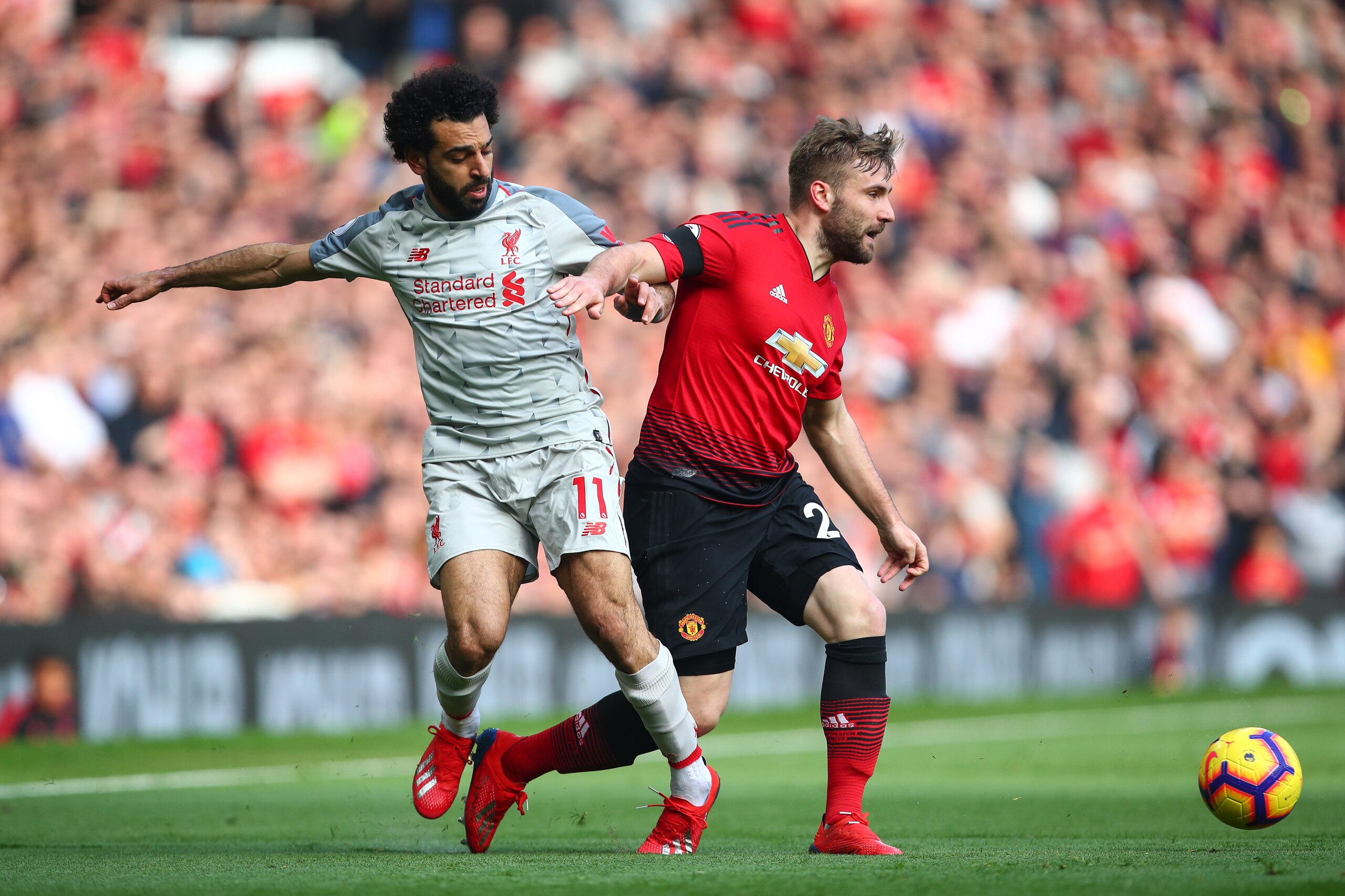 MANCHESTER, ENGLAND - FEBRUARY 24: Mohamed Salah of Liverpool and Luke Shaw of Manchester United during the Premier League match between Manchester United and Liverpool FC at Old Trafford on February 24, 2019 in Manchester, United Kingdom. (Photo by Robbi