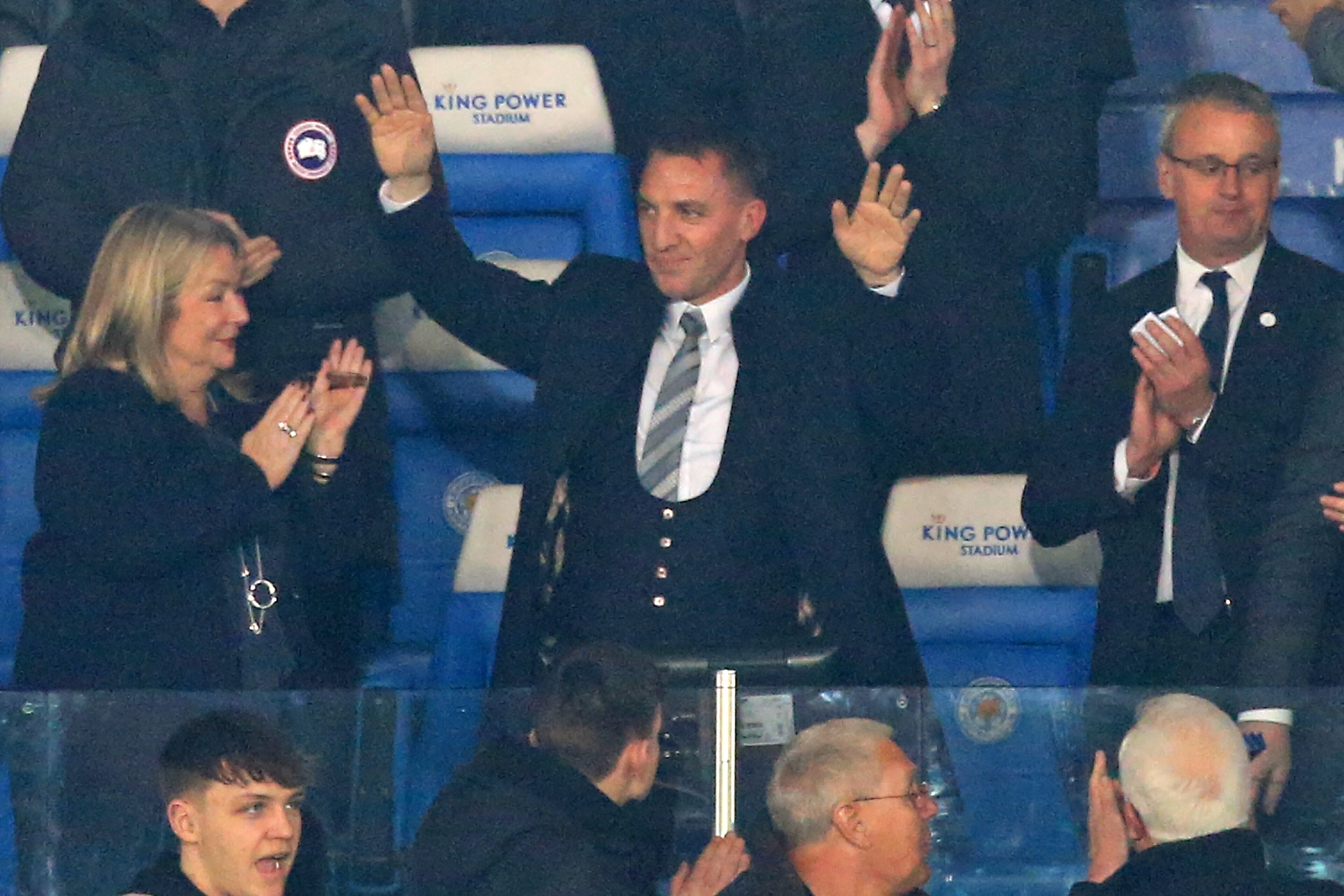 Appointed earlier in the evening, Leicester City's Northern Irish manager Brendan Rodgers (C) is welcomed by supporters ahead of the English Premier League football match between Leicester City and Brighton and Hove Albion at King Power Stadium in Leicest