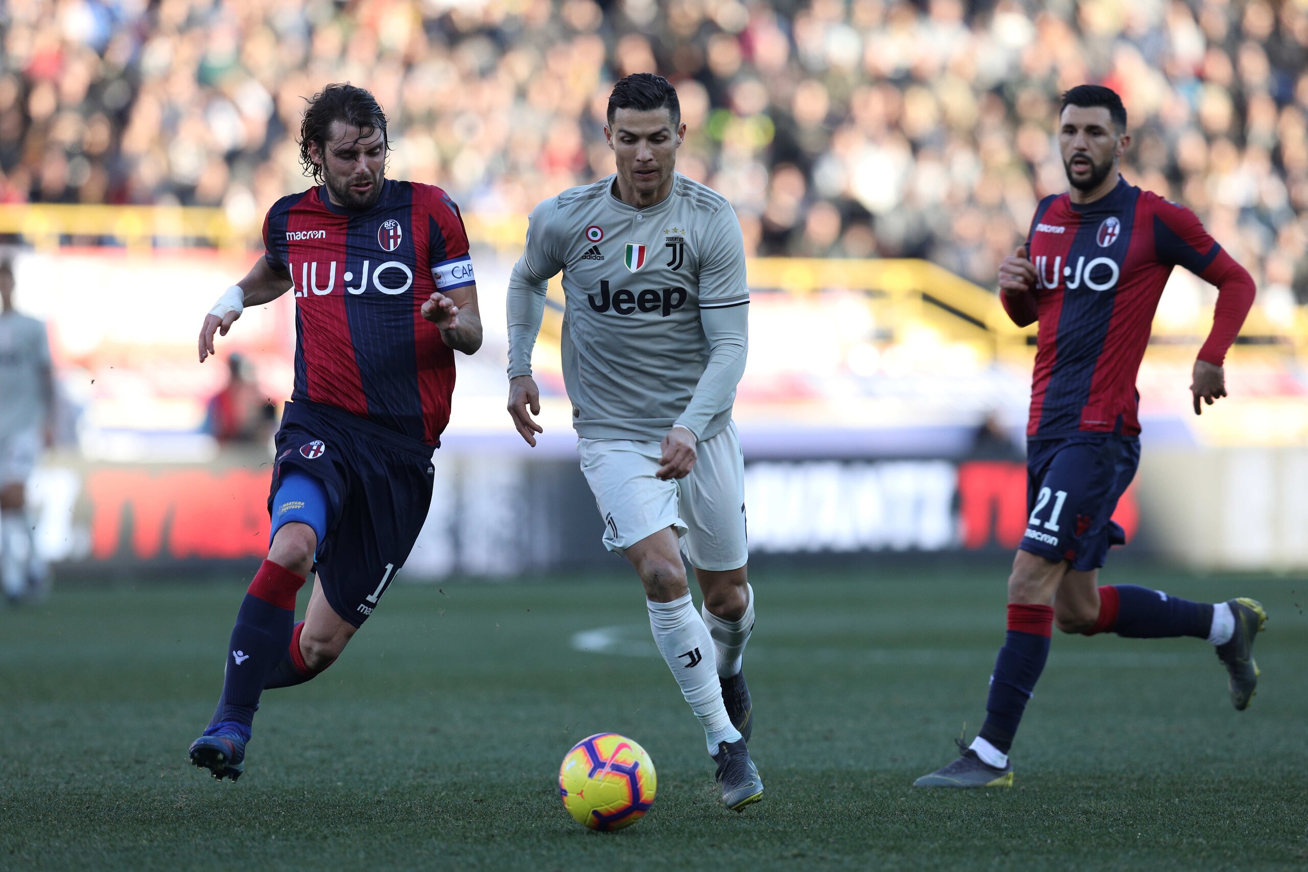 BOLOGNA, ITALY - FEBRUARY 23: (L-R) Andrea Poli of Bologna FC, Cristiano Ronaldo of Juventus, Roberto Soriano of Bologna FC  during the Italian Serie A   match between Bologna v Juventus at the Stadio Renato Dall'Ara on February 23, 2019 in Bologna Italy 