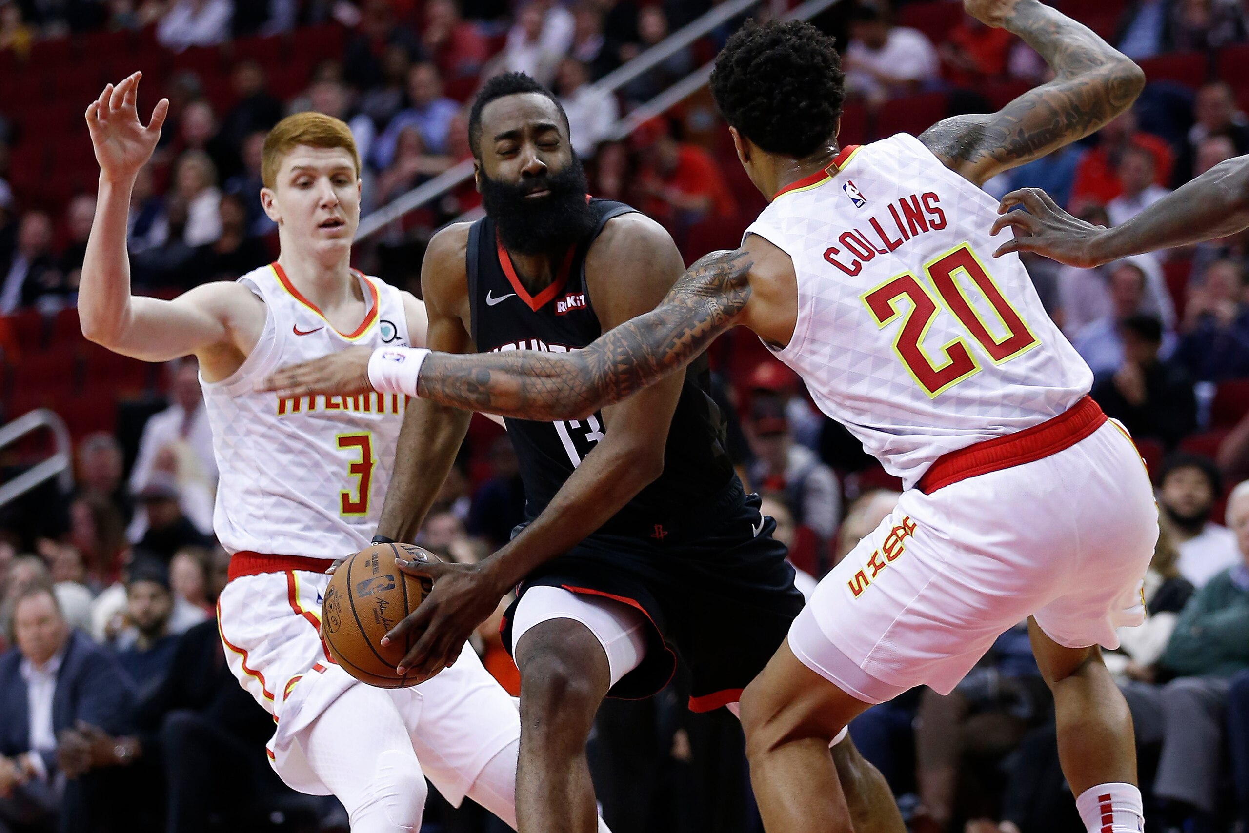 HOUSTON, TEXAS - FEBRUARY 25: James Harden #13 of the Houston Rockets drives between Kevin Huerter #3 of the Atlanta Hawks and John Collins #20 of the Atlanta Hawks at Toyota Center on February 25, 2019 in Houston, Texas. NOTE TO USER: User expressly ackn HOUSTON, TEXAS - FEBRUARY 25: James Harden #13 of the Houston Rockets drives between Kevin Huerter #3 of the Atlanta Hawks and John Collins #20 of the Atlanta Hawks at Toyota Center on February 25, 2019 in Houston, Texas. NOTE TO USER: User expressly ackn