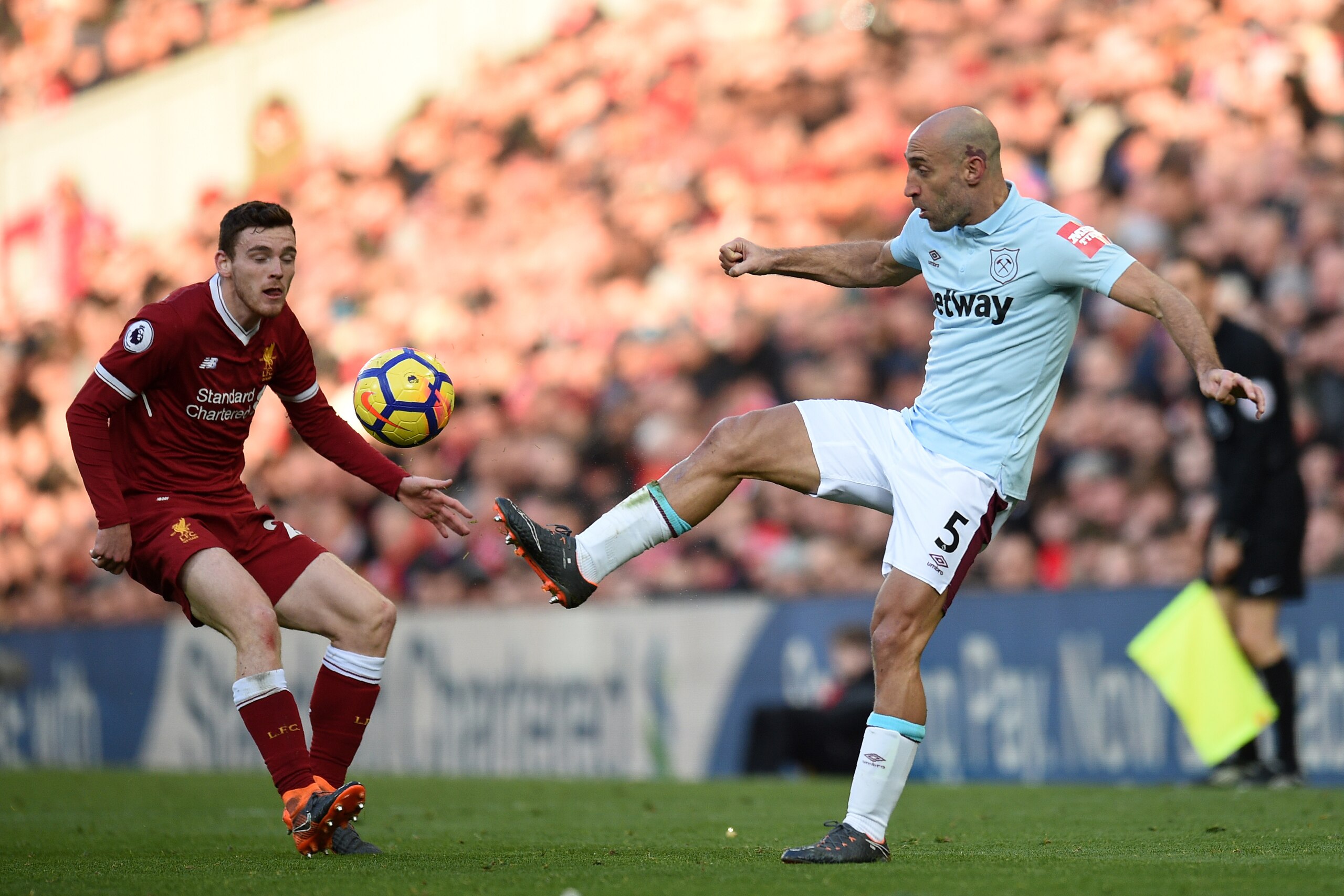 West Ham United's Argentinian defender Pablo Zabaleta (R) controls the ball during the English Premier League football match between Liverpool and West Ham United at Anfield in Liverpool, north west England on February 24, 2018. / AFP PHOTO / Oli SCARFF /