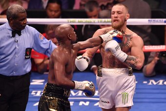 LAS VEGAS, NV - AUGUST 26:  (L-R) Floyd Mayweather Jr. pushes Conor McGregor after the bell rings in their super welterweight boxing match at T-Mobile Arena on August 26, 2017 in Las Vegas, Nevada. Mayweather won by 10th-round TKO. (Photo by Jeff Bottari/