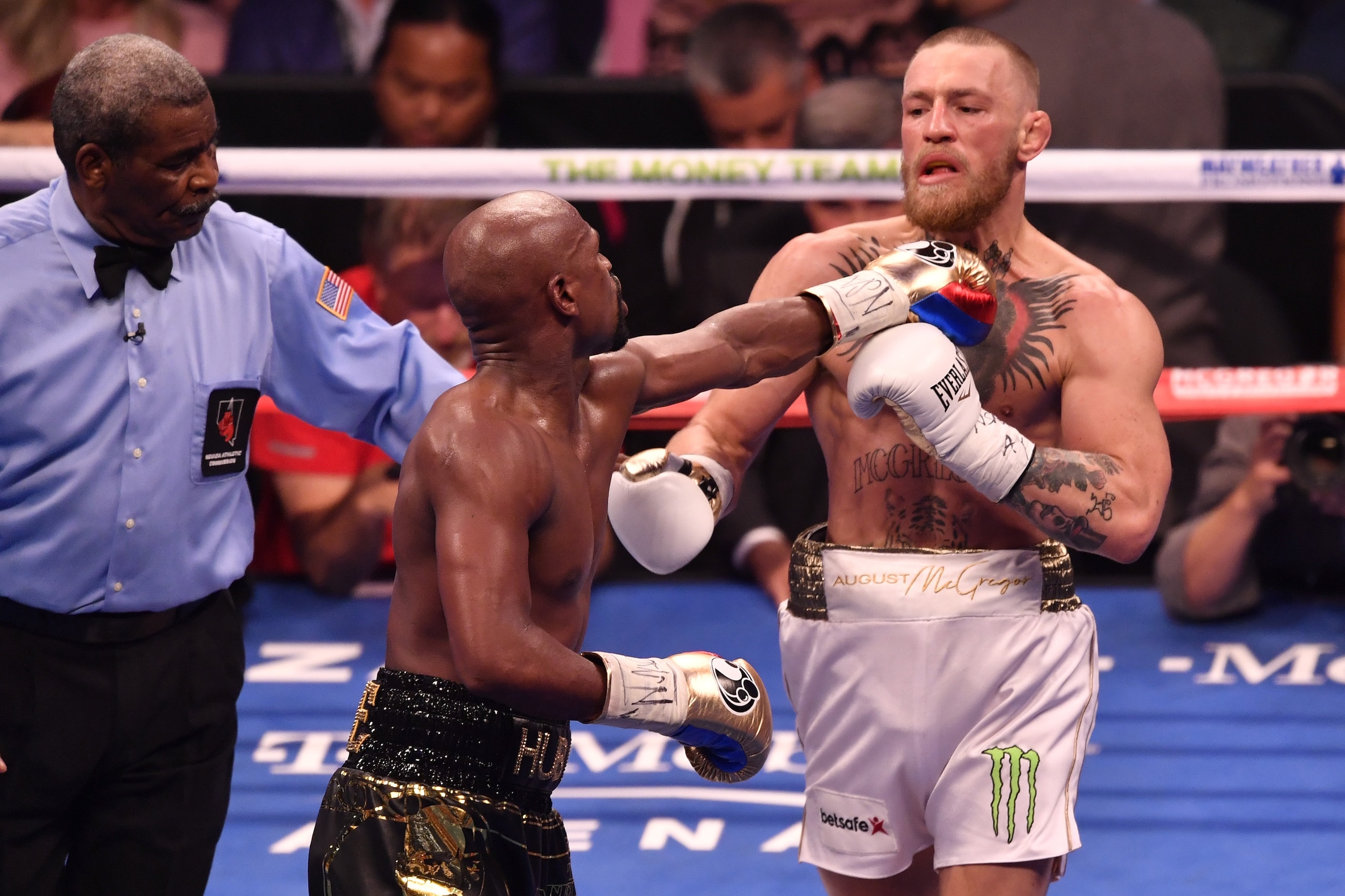 LAS VEGAS, NV - AUGUST 26:  (L-R) Floyd Mayweather Jr. pushes Conor McGregor after the bell rings in their super welterweight boxing match at T-Mobile Arena on August 26, 2017 in Las Vegas, Nevada. Mayweather won by 10th-round TKO. (Photo by Jeff Bottari/