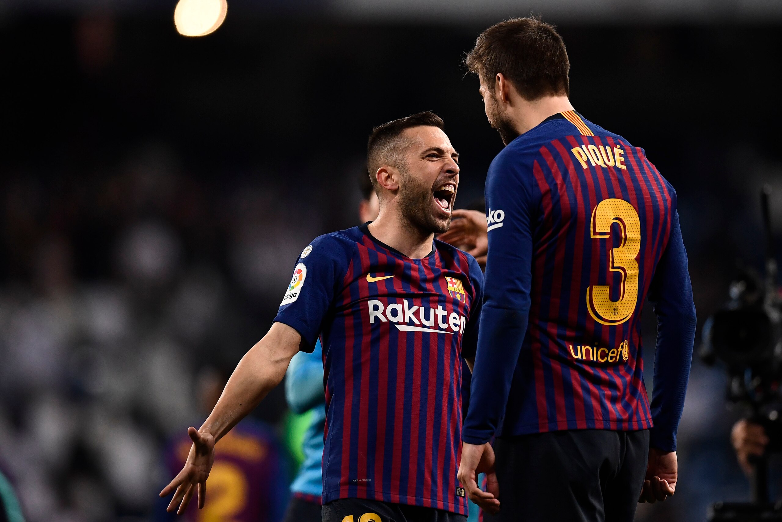 Barcelona's Spanish defender Jordi Alba (L) and Barcelona's Spanish defender Gerard Pique celebrate their win at the end of the Spanish league football match between Real Madrid CF and FC Barcelona at the Santiago Bernabeu stadium in Madrid on March 2, 20 Barcelona's Spanish defender Jordi Alba (L) and Barcelona's Spanish defender Gerard Pique celebrate their win at the end of the Spanish league football match between Real Madrid CF and FC Barcelona at the Santiago Bernabeu stadium in Madrid on March 2, 20