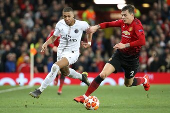 MANCHESTER, ENGLAND - FEBRUARY 12: Kylian Mbappe of PSG, Victor Lindelof of Manchester United during the UEFA Champions League Round of 16 First Leg match between Manchester United (Man U) and Paris Saint-Germain (PSG) at Old Trafford stadium on February 