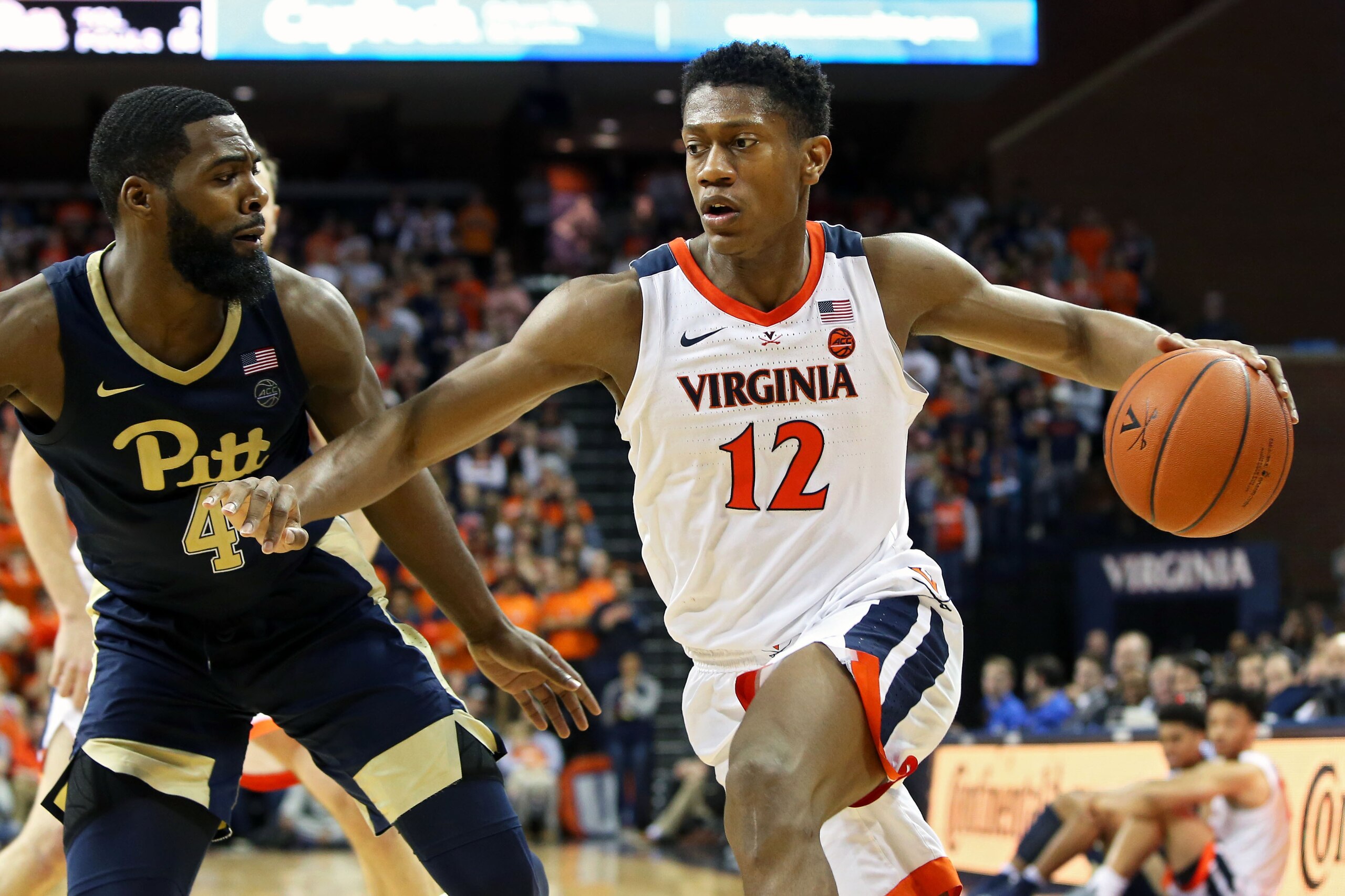 CHARLOTTESVILLE, VA - MARCH 02: De'Andre Hunter #12 of the Virginia Cavaliers drives past Jared Wilson-Frame #4 of the Pittsburgh Panthers in the second half during a game at John Paul Jones Arena on March 2, 2019 in Charlottesville, Virginia. (Photo by R