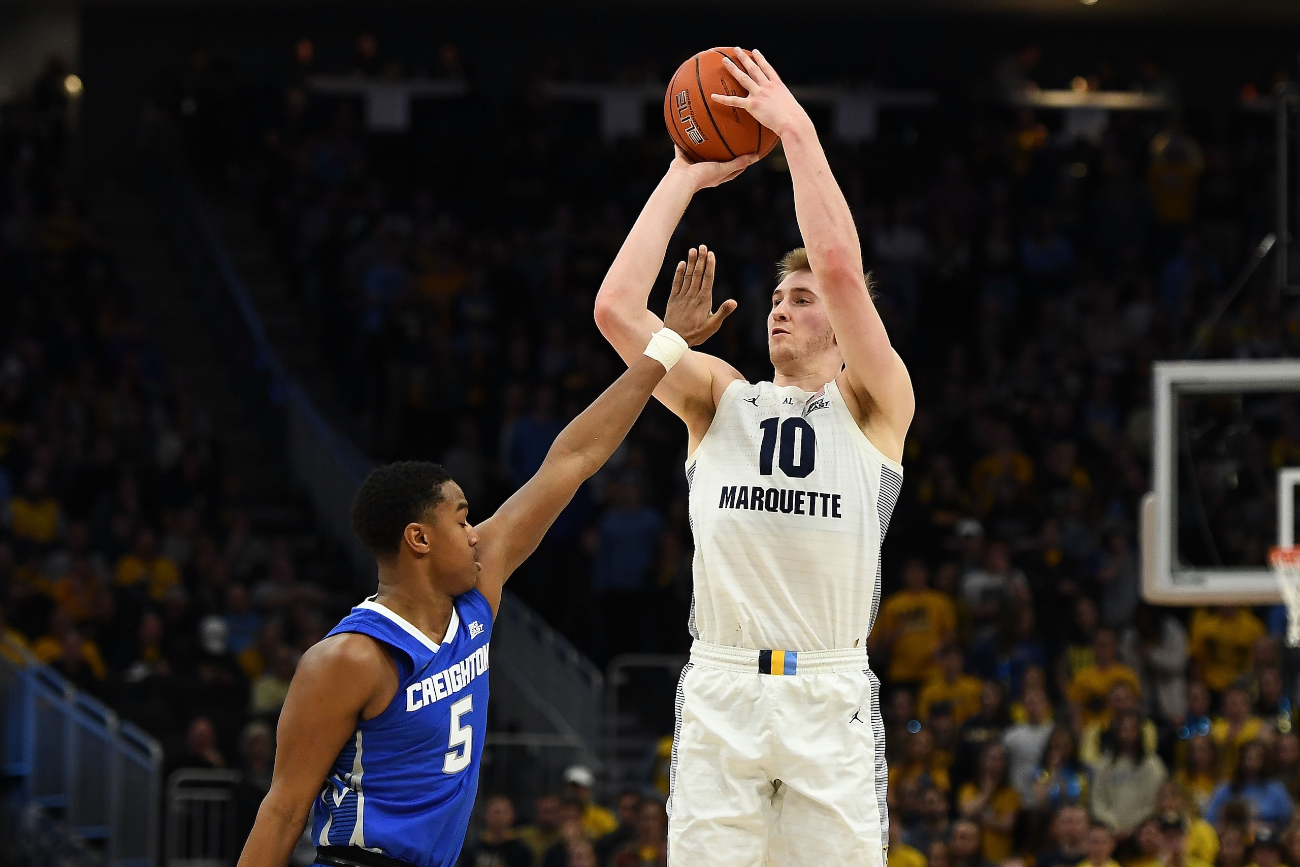 MILWAUKEE, WISCONSIN - MARCH 03:  Sam Hauser #10 of the Marquette Golden Eagles shoots over Ty-Shon Alexander #5 of the Creighton Bluejays during the first half of a game at Fiserv Forum on March 03, 2019 in Milwaukee, Wisconsin. (Photo by Stacy Revere/Ge