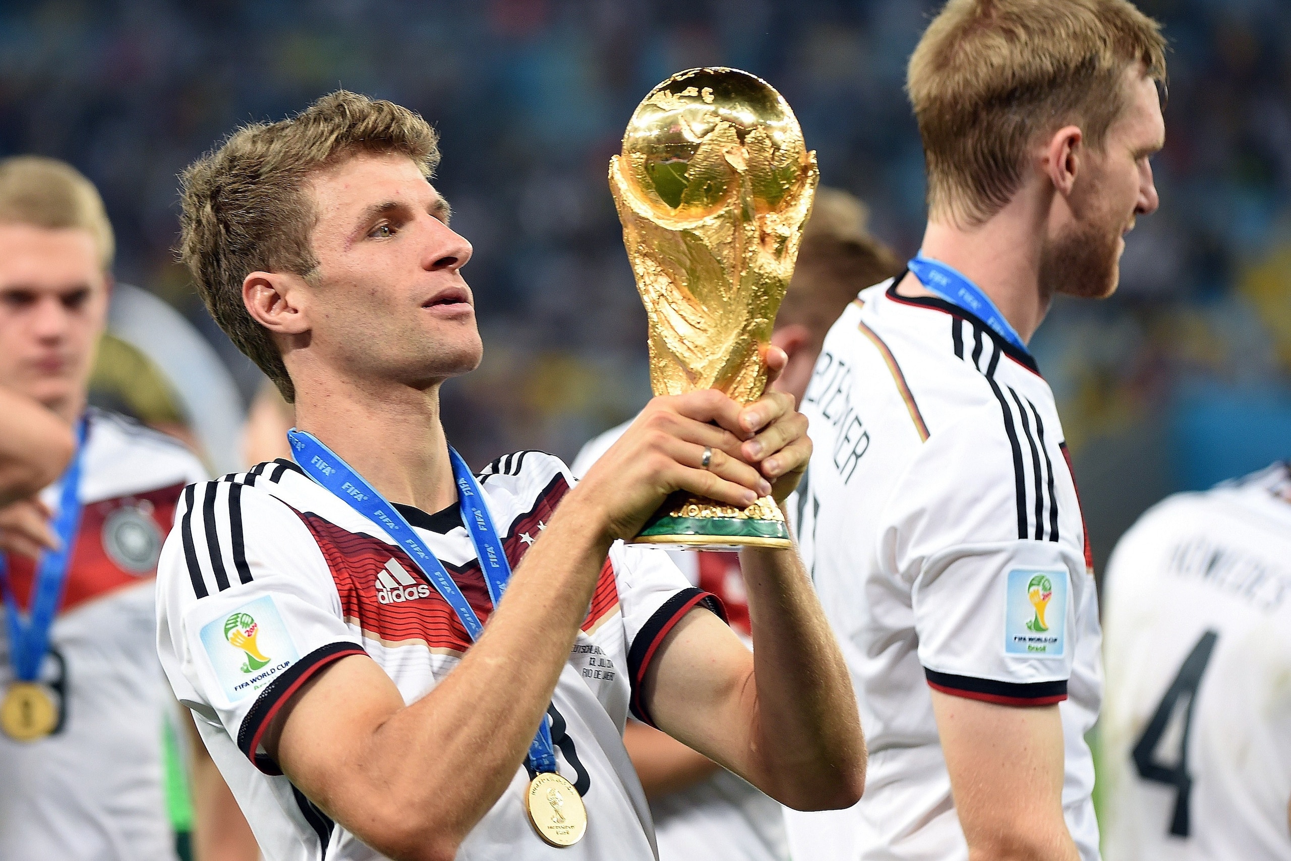 Germany's forward Thomas Mueller holds the World Cup trophy after winning the final football match between Germany and Argentina for the FIFA World Cup at The Maracana Stadium in Rio de Janeiro on July 13, 2014.   AFP PHOTO / PATRIK STOLLARZ        (Photo
