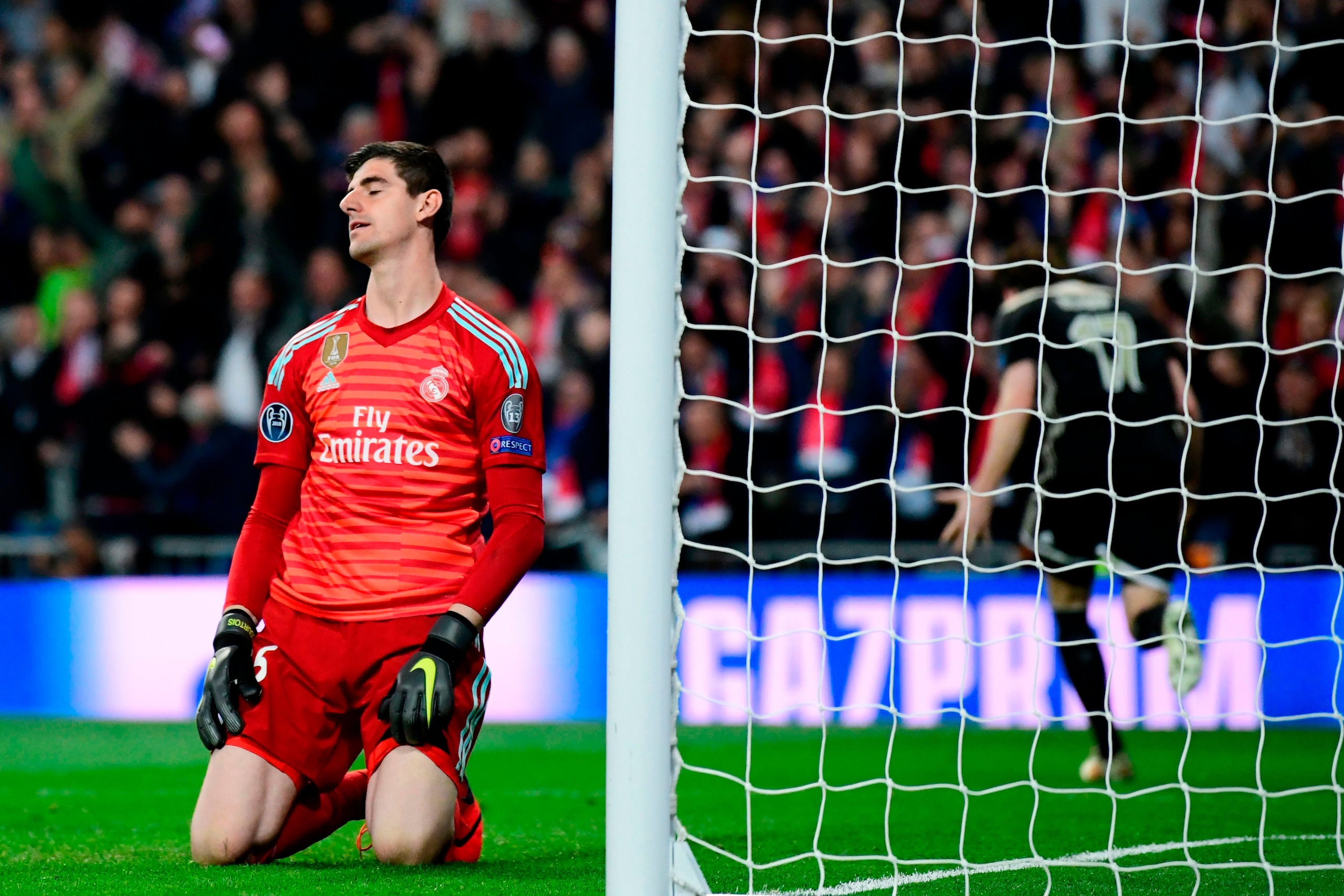 Real Madrid's Belgian goalkeeper Thibaut Courtois reacts as he concedes a fourth goal during the UEFA Champions League round of 16 second leg football match between Real Madrid CF and Ajax at the Santiago Bernabeu stadium in Madrid on March 5, 2019. (Phot