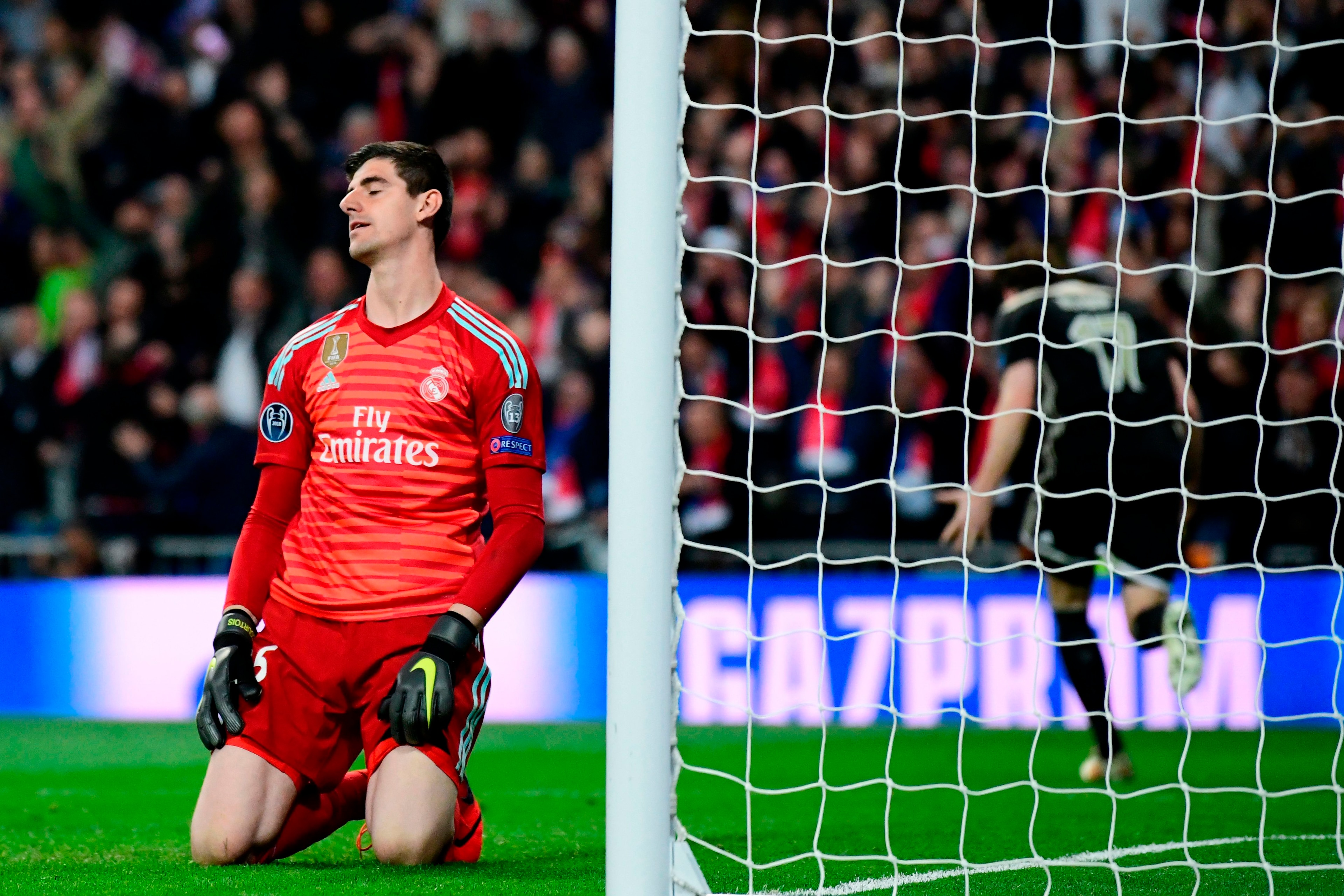 Real Madrid's Belgian goalkeeper Thibaut Courtois reacts as he concedes a fourth goal during the UEFA Champions League round of 16 second leg football match between Real Madrid CF and Ajax at the Santiago Bernabeu stadium in Madrid on March 5, 2019. (Phot