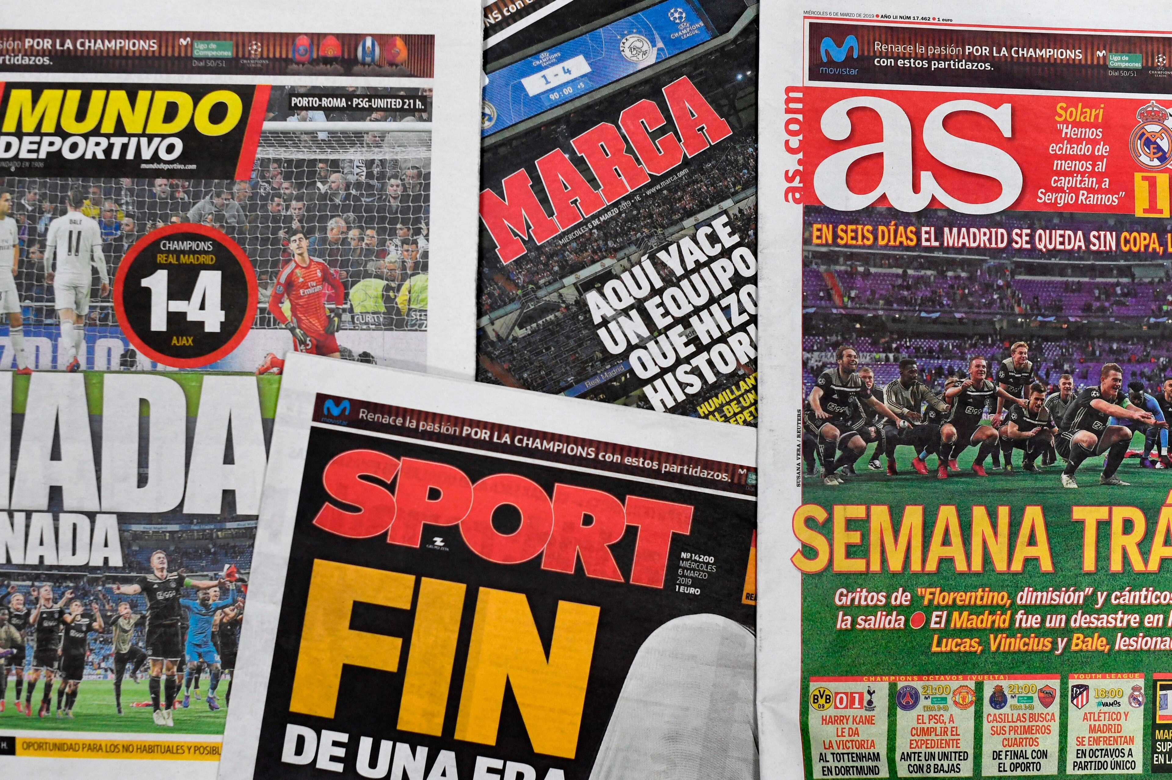 A picture shows the frontpages of Spanish sports newspapers in Madrid on March 6, 2019, a day after Ajax beat Real Madrid 4-1 in the UEFA Champions League round of 16 second leg football match at the Santiago Bernabeu stadium. - The reign of Real Madrid i