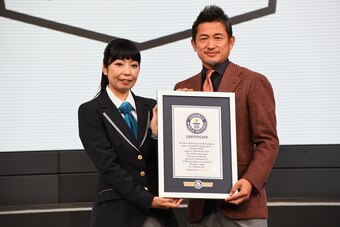 TOKYO, JAPAN - FEBRUARY 15:  (EDITORIAL USE ONLY) Kazuyoshi Miura receives the Guinness World Record certificate as he is recognised as the 'Oldest professional football player to score a competitive league goal' during the J.League Kick Off Conference on