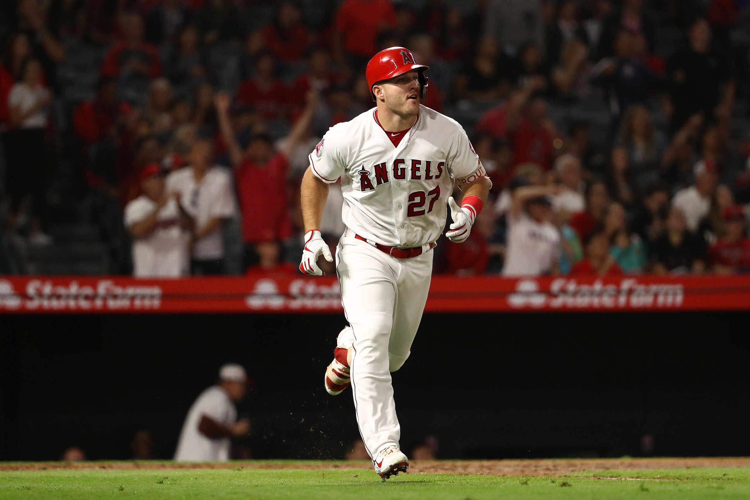 ANAHEIM, CA - SEPTEMBER 28:  Mike Trout #27 of the Los Angeles Angels of Anaheim watches his hit go for a two-run homerun during the third inning of the MLB game against the Oakland Athletics at Angel Stadium on September 28, 2018 in Anaheim, California. 