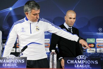 Former French football player Zinedine Zidane (R) and Real Madrid's Portuguese coach Jose Mourinho (L) arrive for a press conference on the eve of UEFA Champions league football match Lyon versus Real Madrid on February 21, 2011 at the Gerland stadium in 