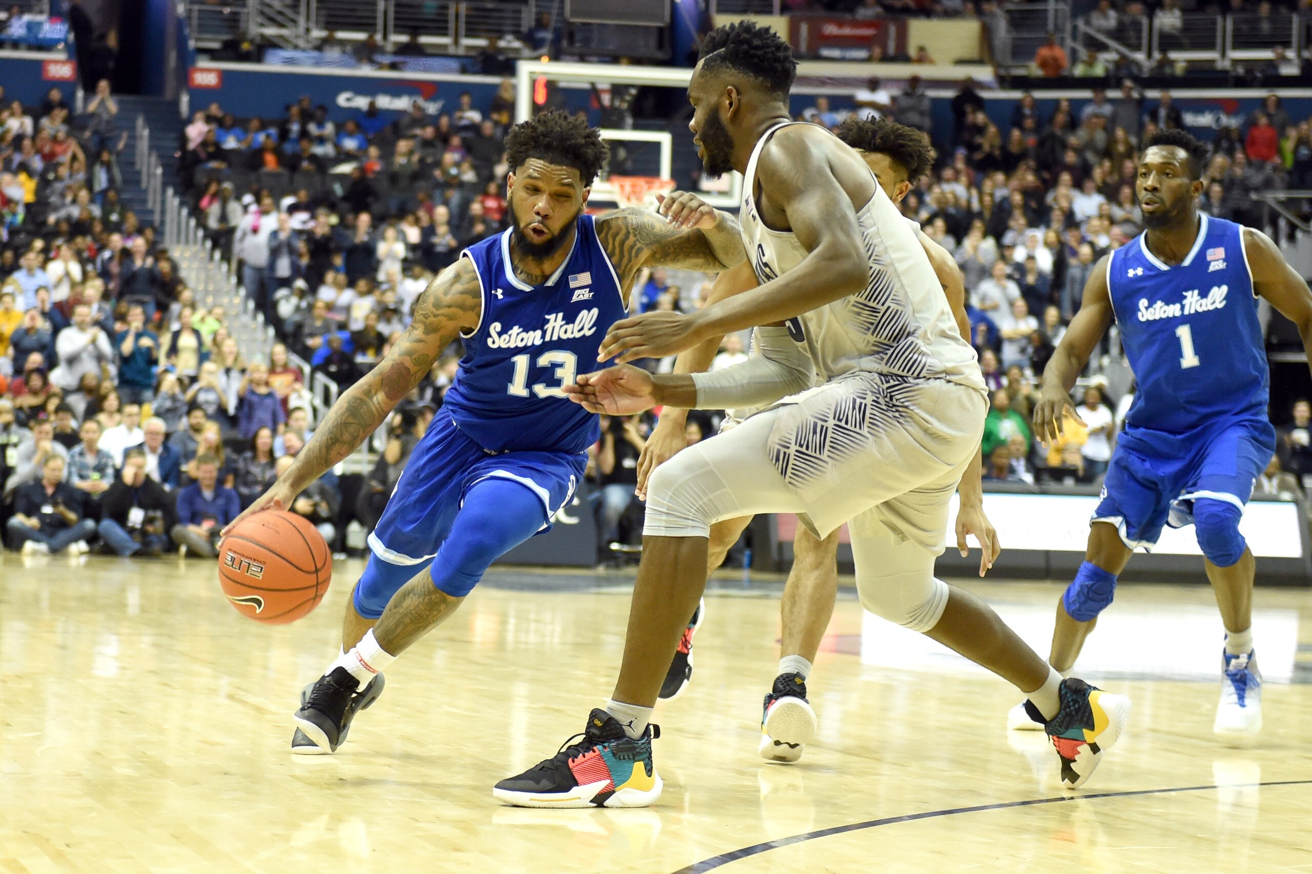 WASHINGTON, DC - MARCH 02 :  Myles Powell #13 of the Seton Hall Pirates dribbles around Jessie Govan #15 of the Georgetown Hoyas during a college basketball game at the Capital One Arena on March 2, 2019 in Washington, DC.  (Photo by Mitchell Layton/Getty