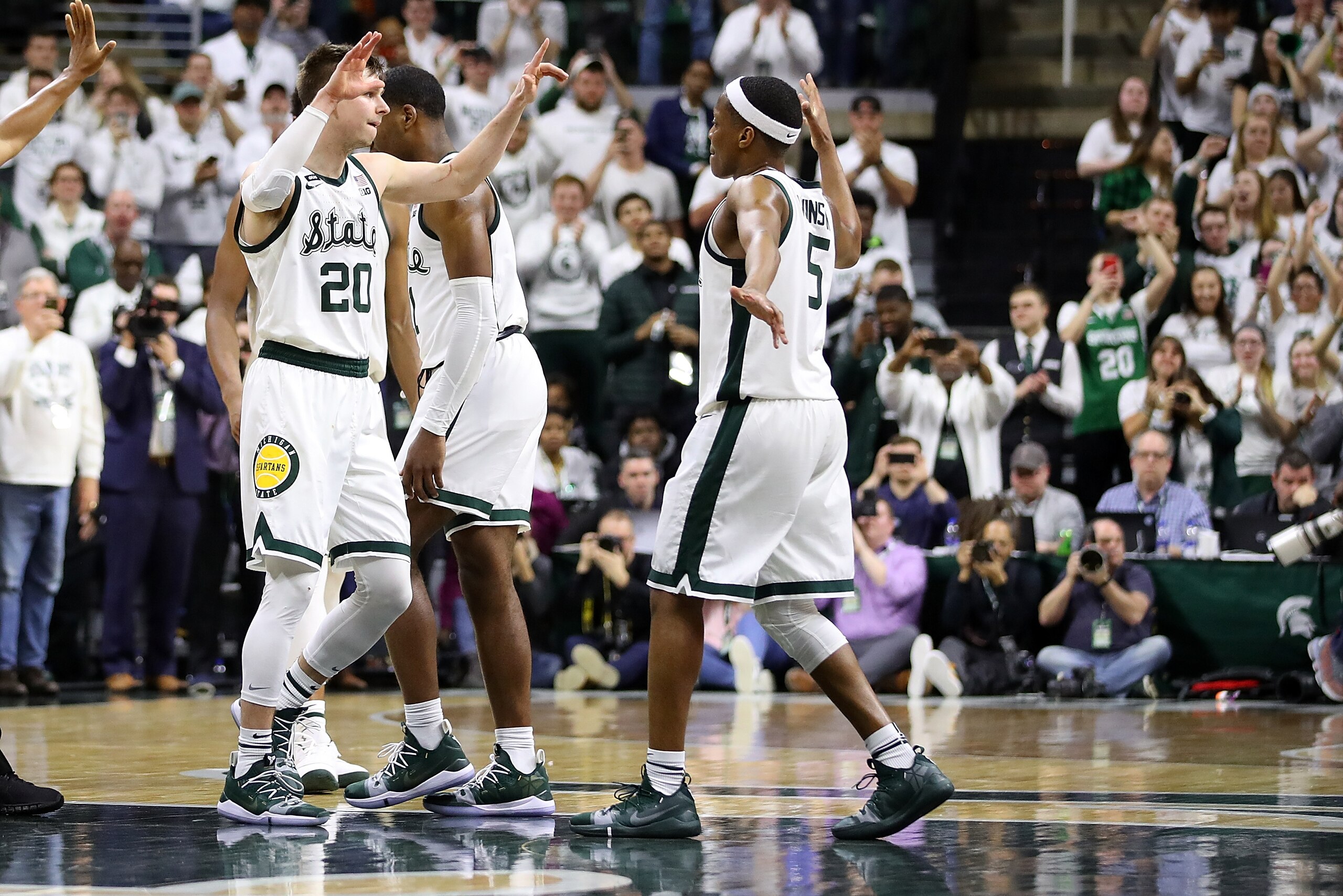 EAST LANSING, MI - MARCH 09:  Matt McQuaid #20 of the Michigan State Spartans celebrates with Cassius Winston #5 after defeating the Michigan Wolverines 75-63 at Breslin Center on March 9, 2019 in East Lansing, Michigan. (Photo by Gregory Shamus/Getty Ima
