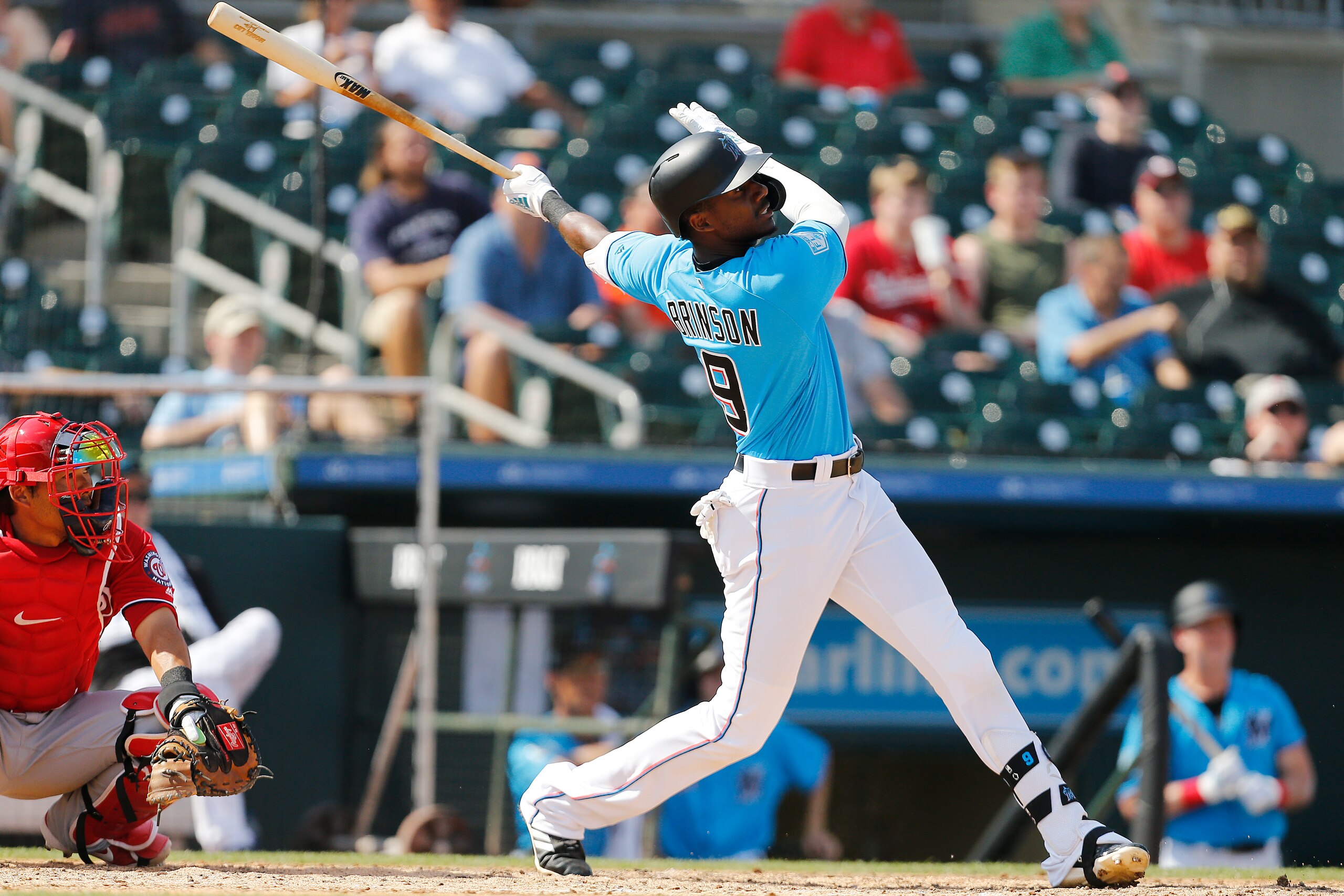 JUPITER, FLORIDA - MARCH 04:  Lewis Brinson #9 of the Miami Marlins hits a solo home run in the fifth inning against the Washington Nationals during the Grapefruit League spring training game at Roger Dean Stadium on March 04, 2019 in Jupiter, Florida. (P