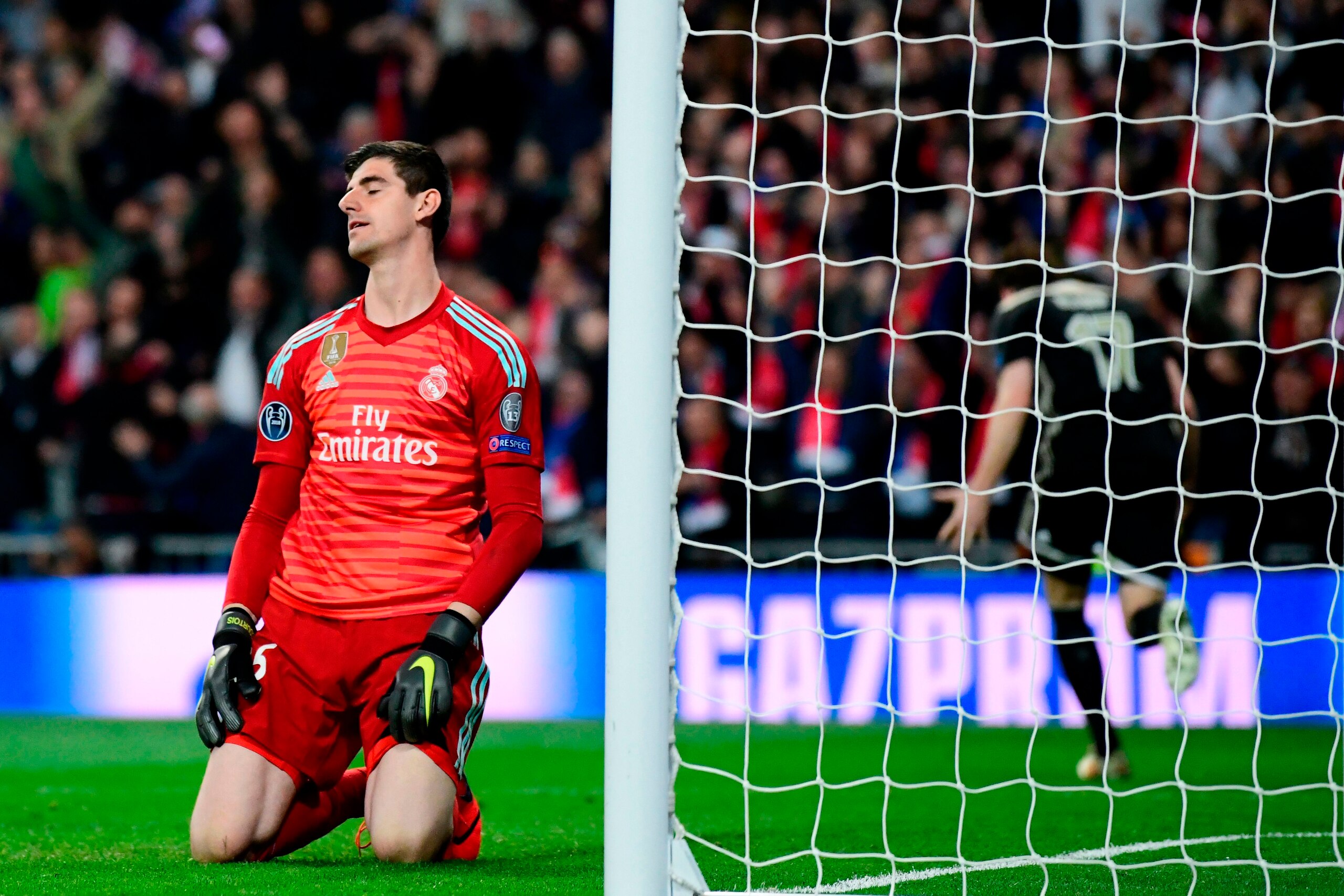 Real Madrid's Belgian goalkeeper Thibaut Courtois reacts as he concedes a fourth goal during the UEFA Champions League round of 16 second leg football match between Real Madrid CF and Ajax at the Santiago Bernabeu stadium in Madrid on March 5, 2019. (Phot