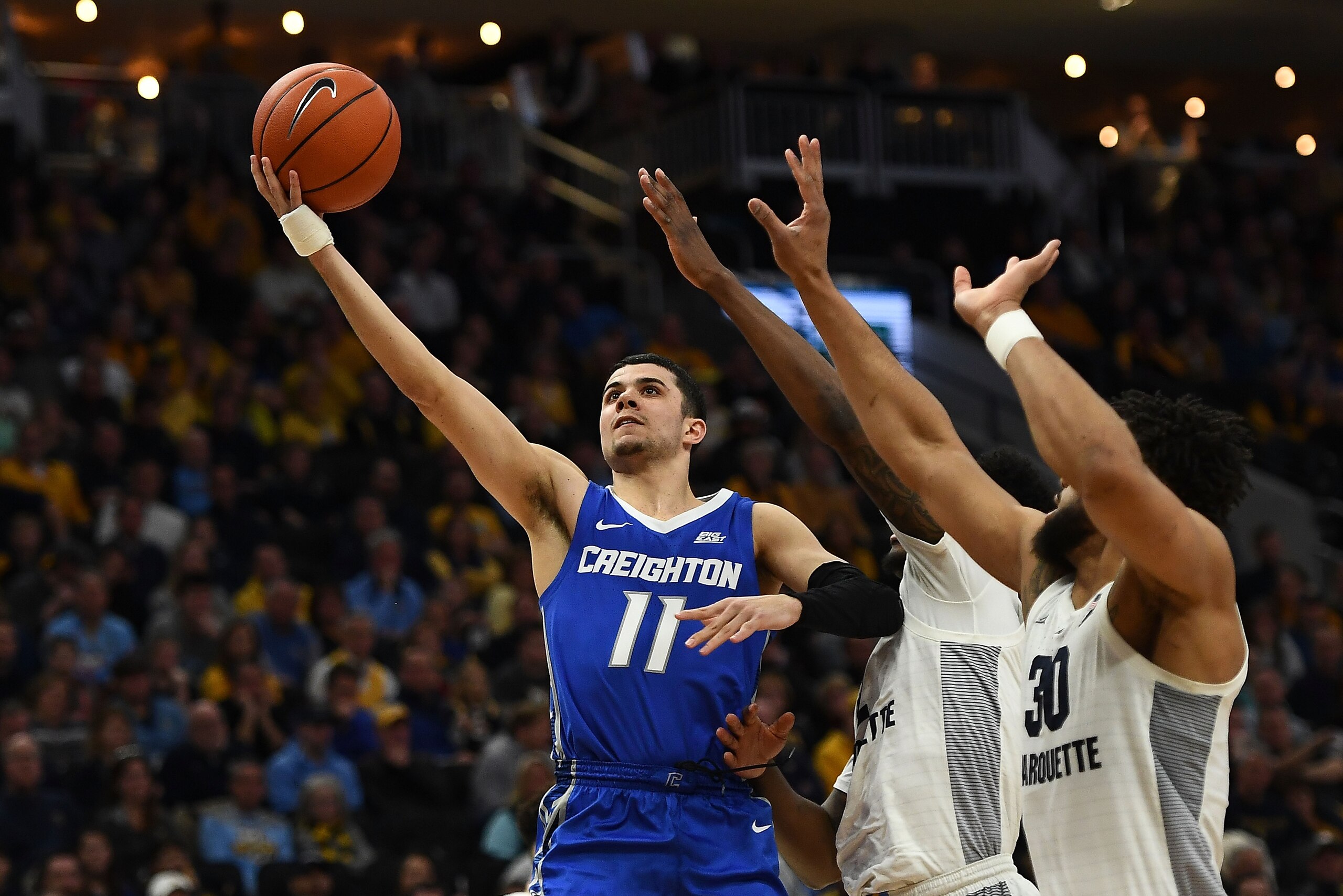 MILWAUKEE, WISCONSIN - MARCH 03:  Marcus Zegarowski #11 of the Creighton Bluejays is defended by Sacar Anim #2 and Ed Morrow #30 of the Marquette Golden Eagles during the second half of a game at Fiserv Forum on March 03, 2019 in Milwaukee, Wisconsin. (Ph